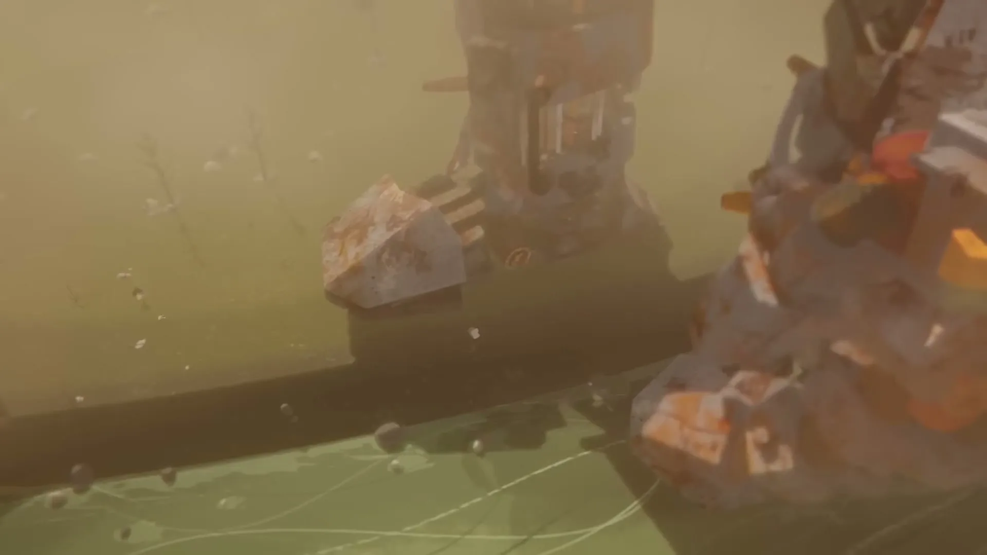 A giant, rusty, blocky robot foot steps into a murky green liquid, creating ripples and splashes in a hazy, desolate landscape.