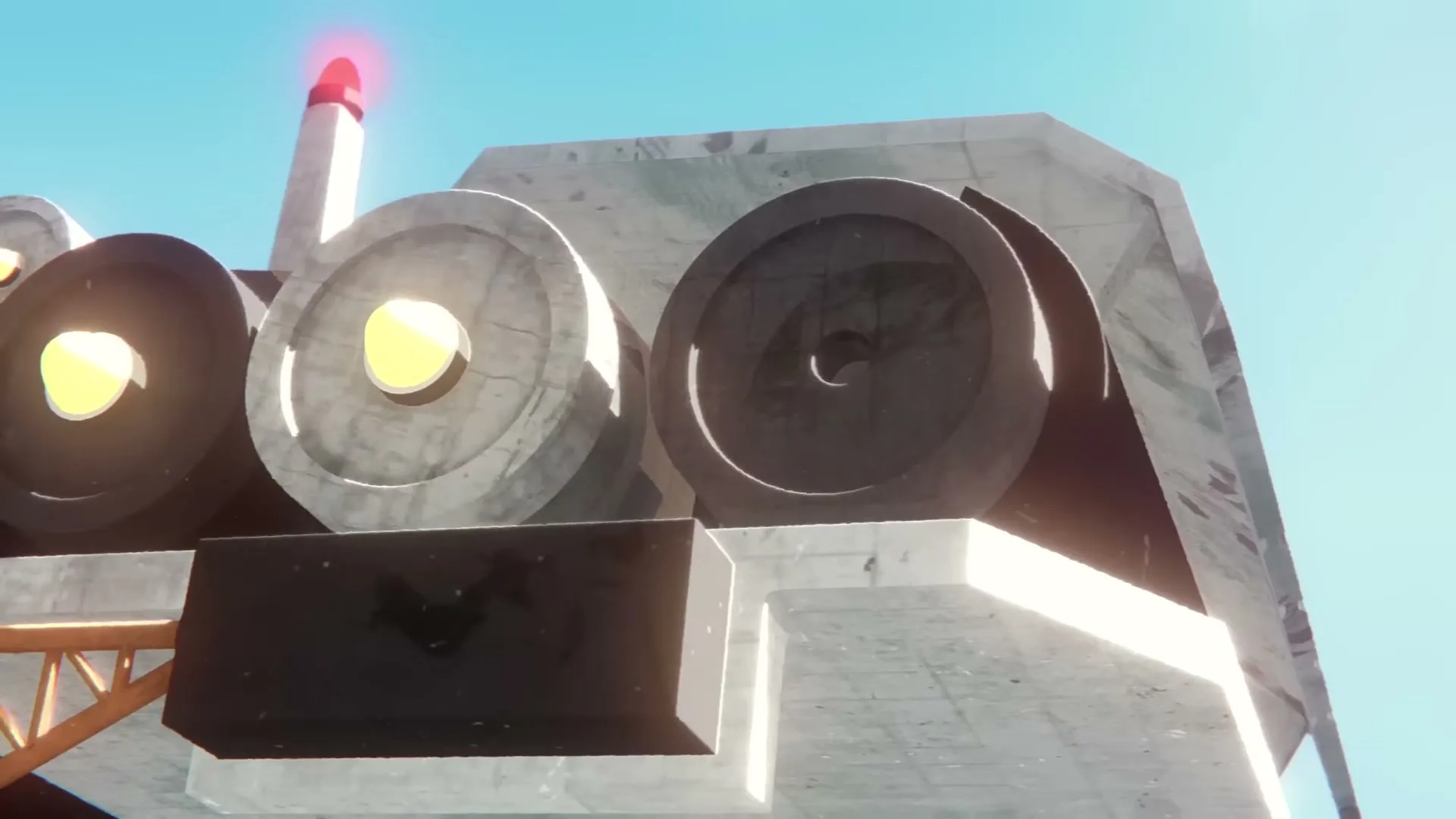 A low-angle shot shows a large, blocky, concrete-like robot head with glowing yellow eyes and a red light on top, against a clear blue sky.