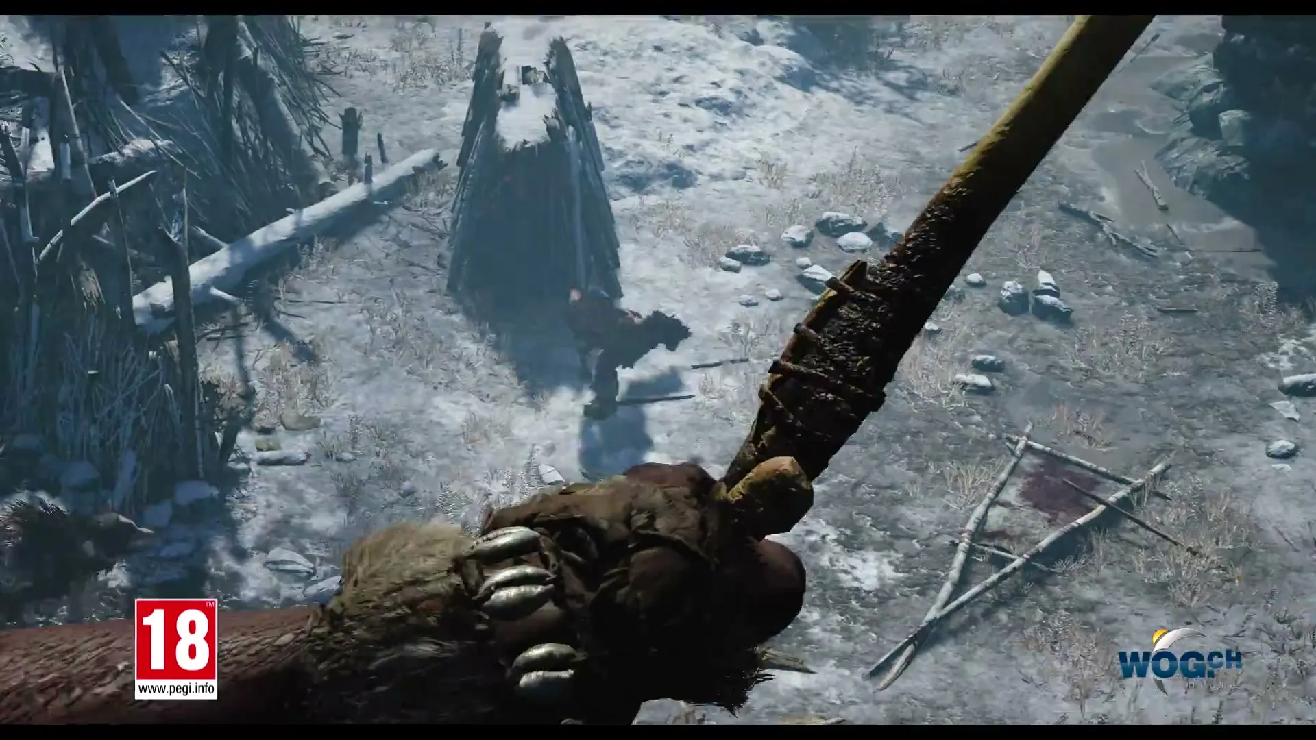 A first-person perspective of a character holding a weapon, looking down at a snowy, rocky landscape with other characters fighting below.