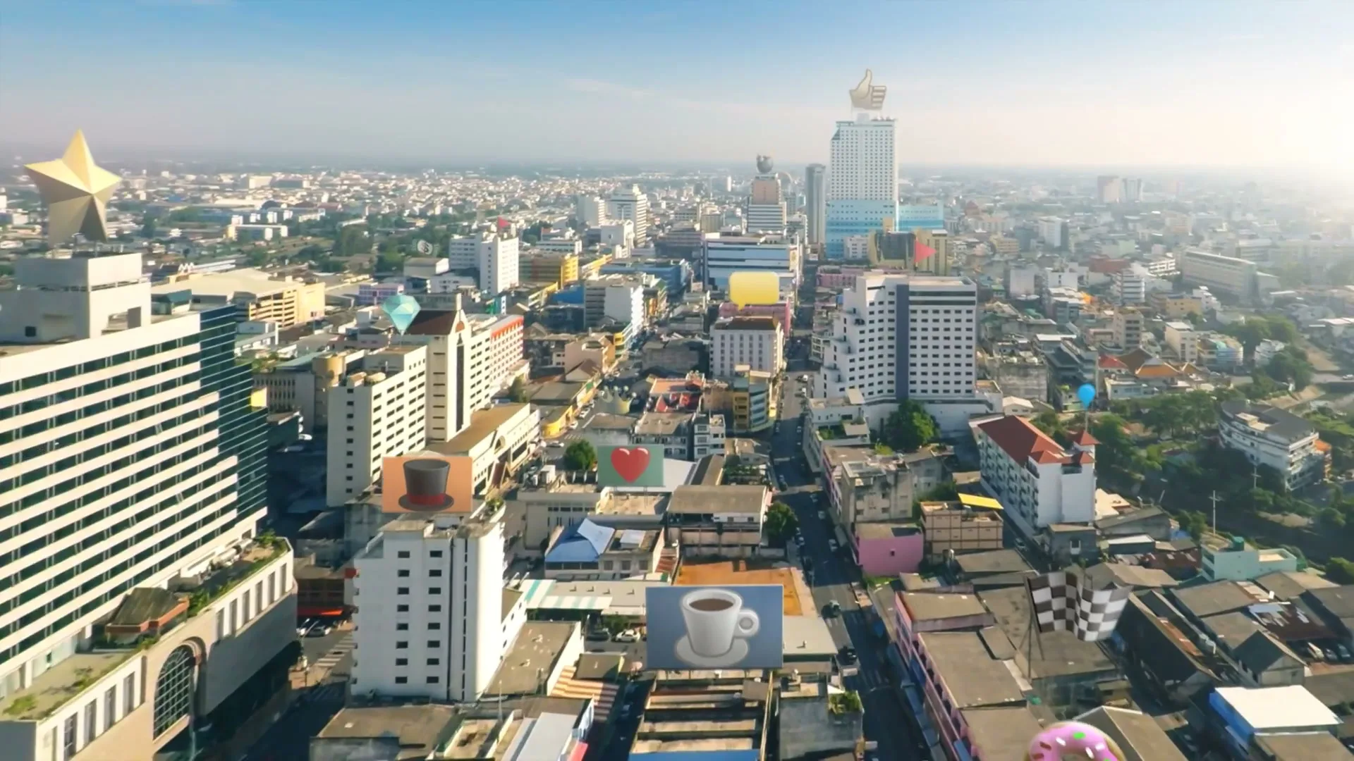 An aerial shot of a city with various emoji-like icons floating above buildings, under a clear blue sky.