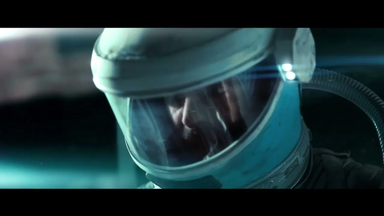 A male astronaut in a blue and white helmet looks around with a serious expression in a dark, futuristic setting with lens flares.
