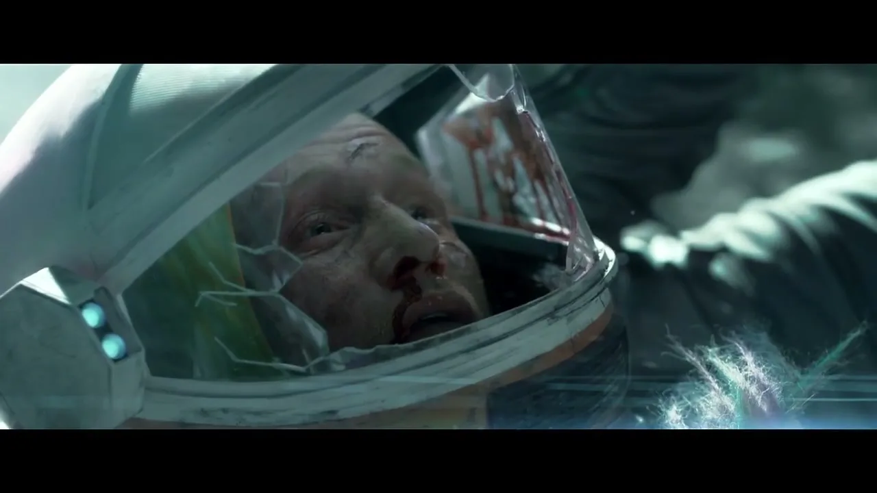 A male astronaut with a bloody face and a cracked helmet lies injured in a space environment, looking up with a pained expression.