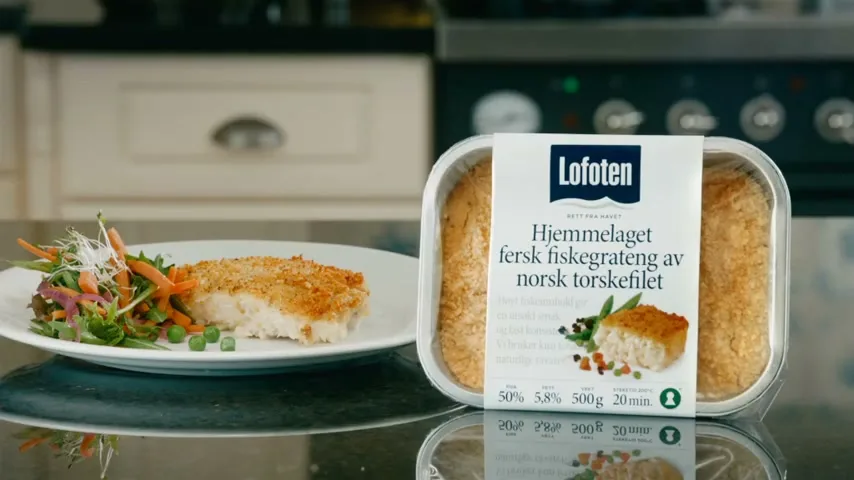 A Lofoten fish gratin meal, with a side salad, is presented on a kitchen counter, showcasing the product packaging and a cooked portion.