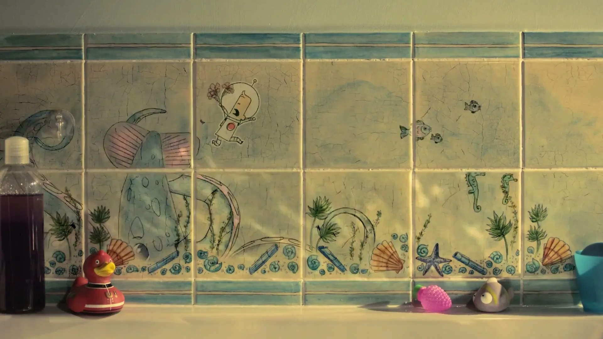 A red rubber duck and bath toys sit on the edge of a bathtub, with illustrated tiles depicting an underwater scene and an astronaut on the wall.