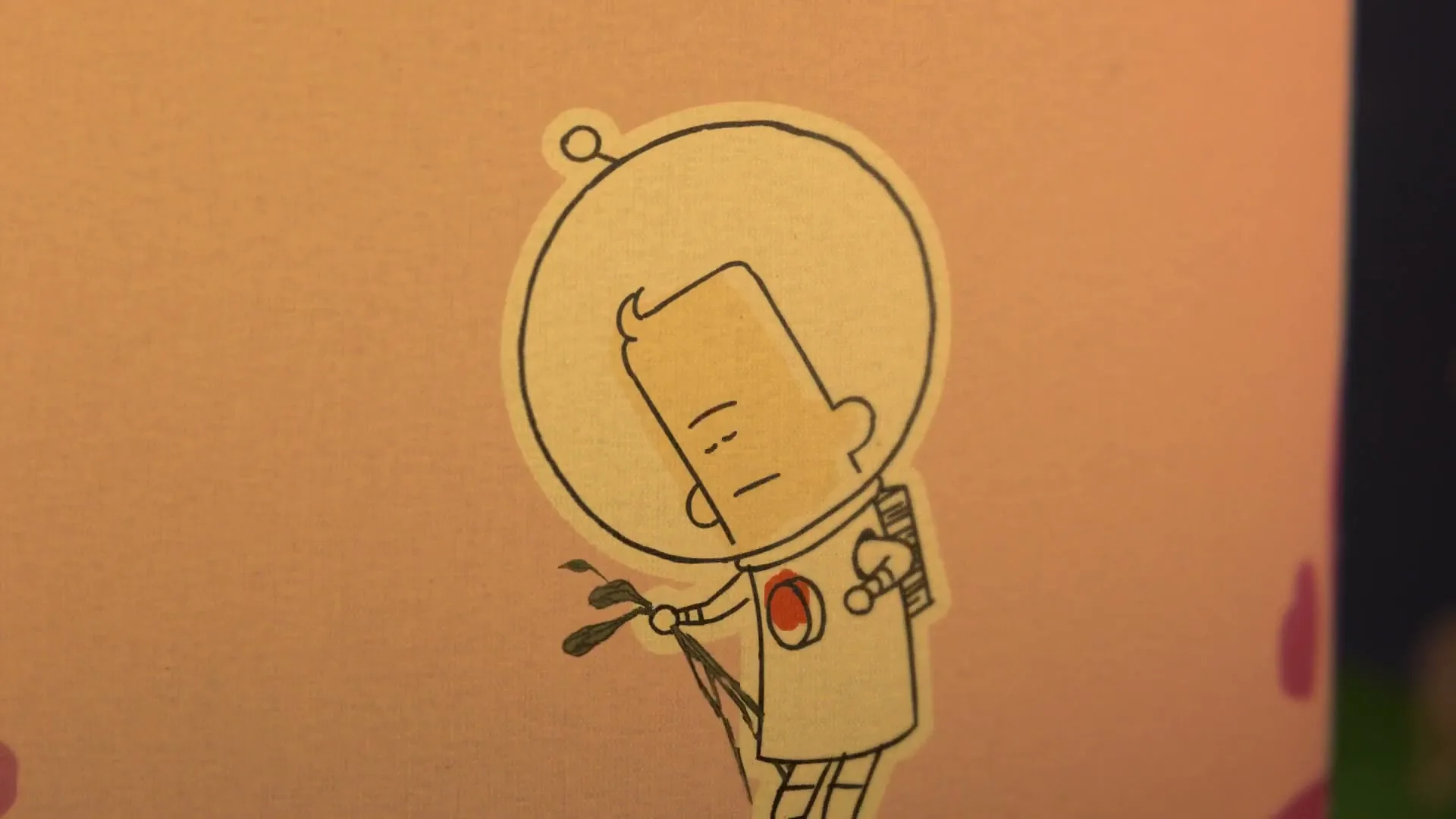 A cartoon astronaut sticker on a pink background looks down sadly, then looks up with a neutral expression, holding a small plant.