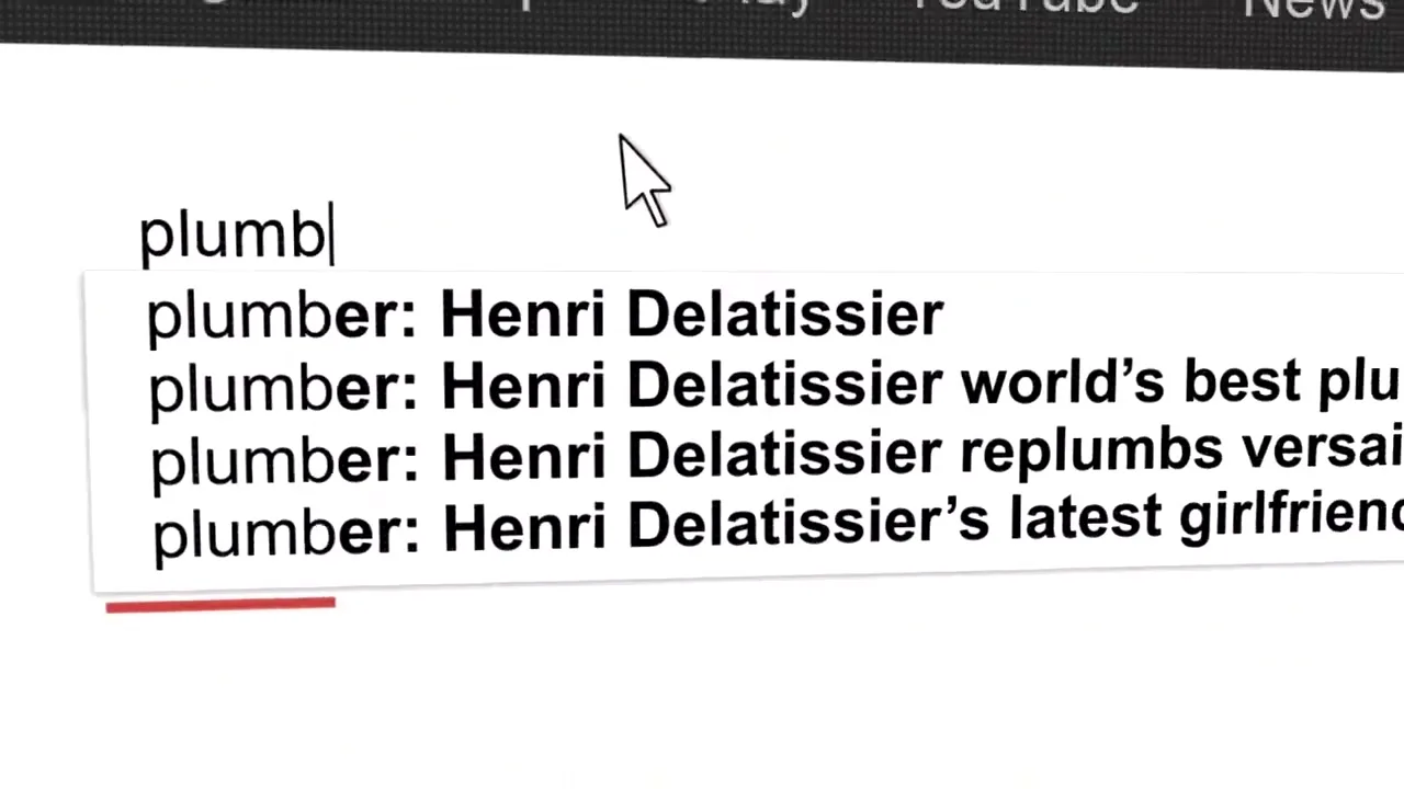 A computer screen shows a search bar with the word "plumber" being typed, and search suggestions appearing below it.