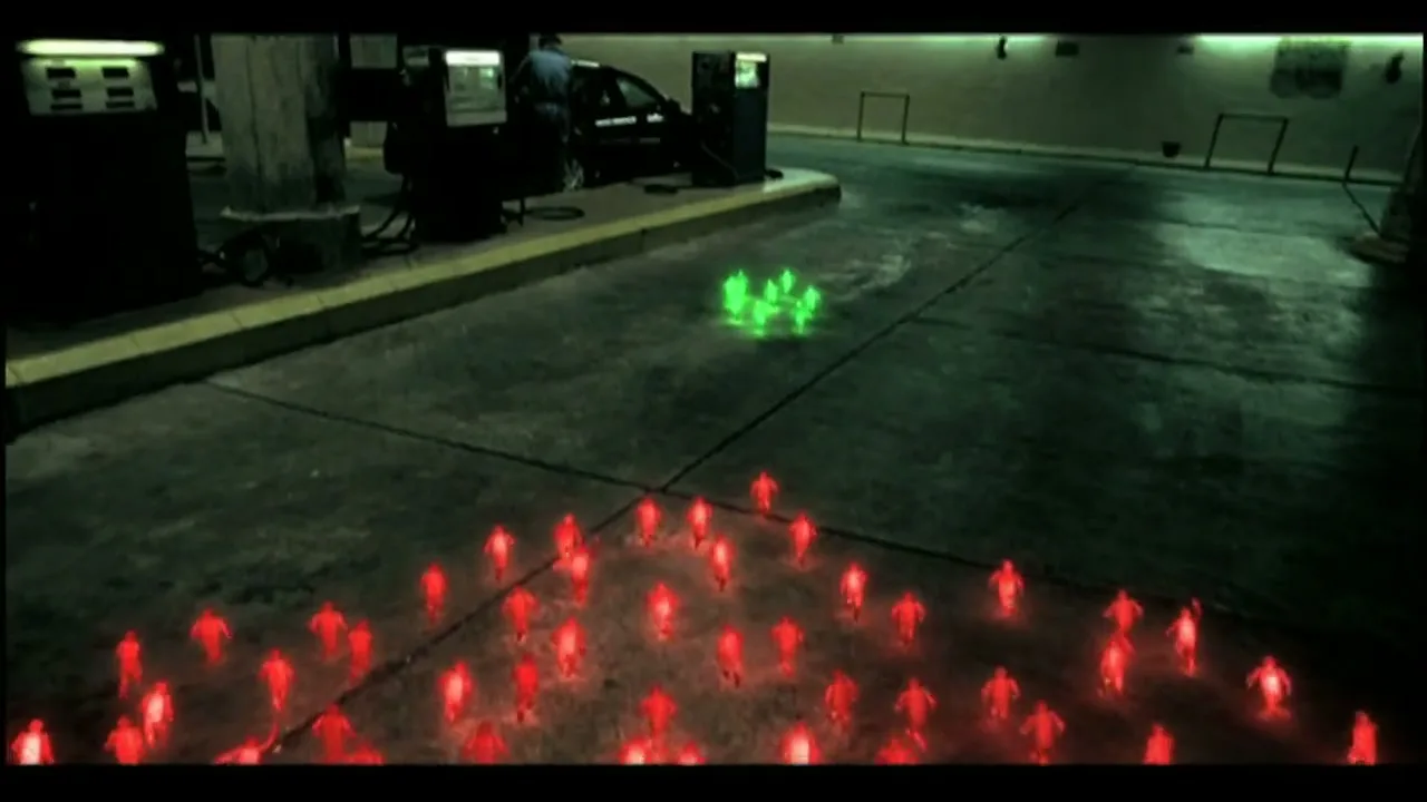 A wide shot shows a dark, empty gas station at night, with a large group of small, glowing red figures in the foreground and a smaller group of green figures in the background.