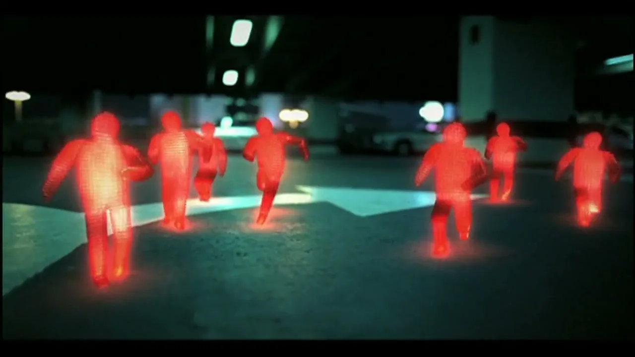 Several glowing red, wireframe-like figures run across a dark, empty street at night, with blurred city lights in the background.