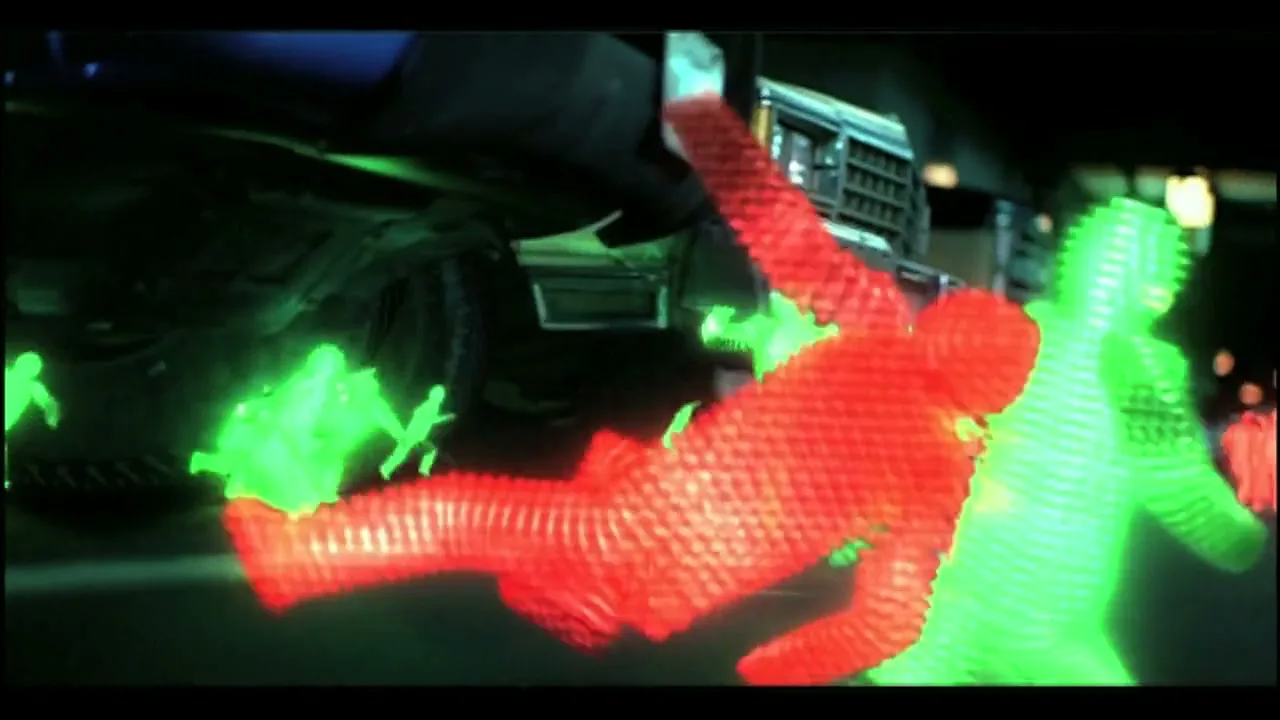 Green and red wireframe figures, representing people, are running and falling on a dark road next to a large truck at night.