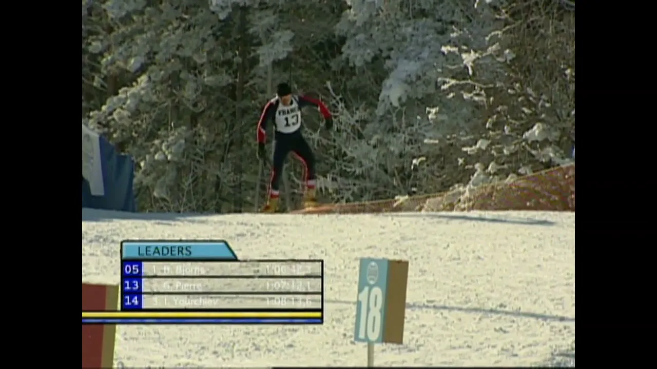 A male biathlete in a red and black suit skis down a snowy slope with trees in the background, as a scoreboard overlay shows "LEADERS".