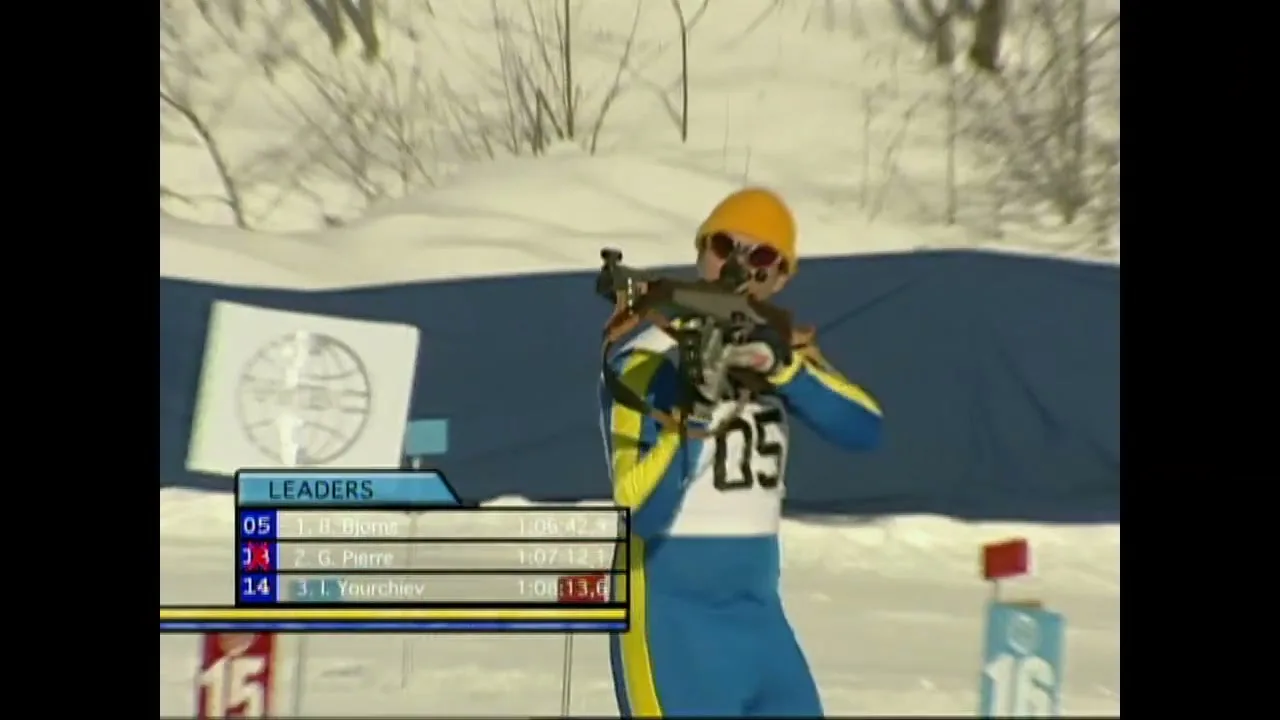 A male biathlete in a blue and yellow suit with number 05 on his back aims a rifle at a target in a snowy outdoor setting during a competition.