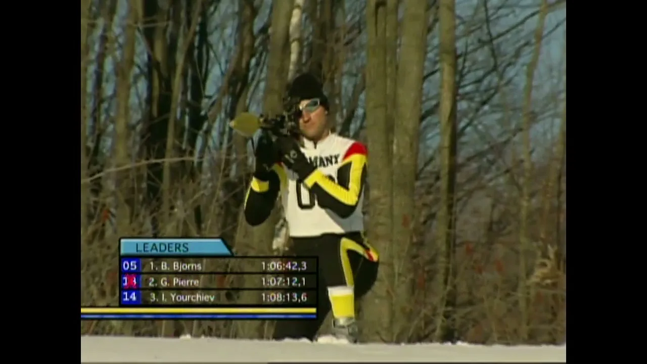 A male biathlete in a white, yellow, and black uniform kneels in the snow, aiming and firing a rifle in a snowy forest.