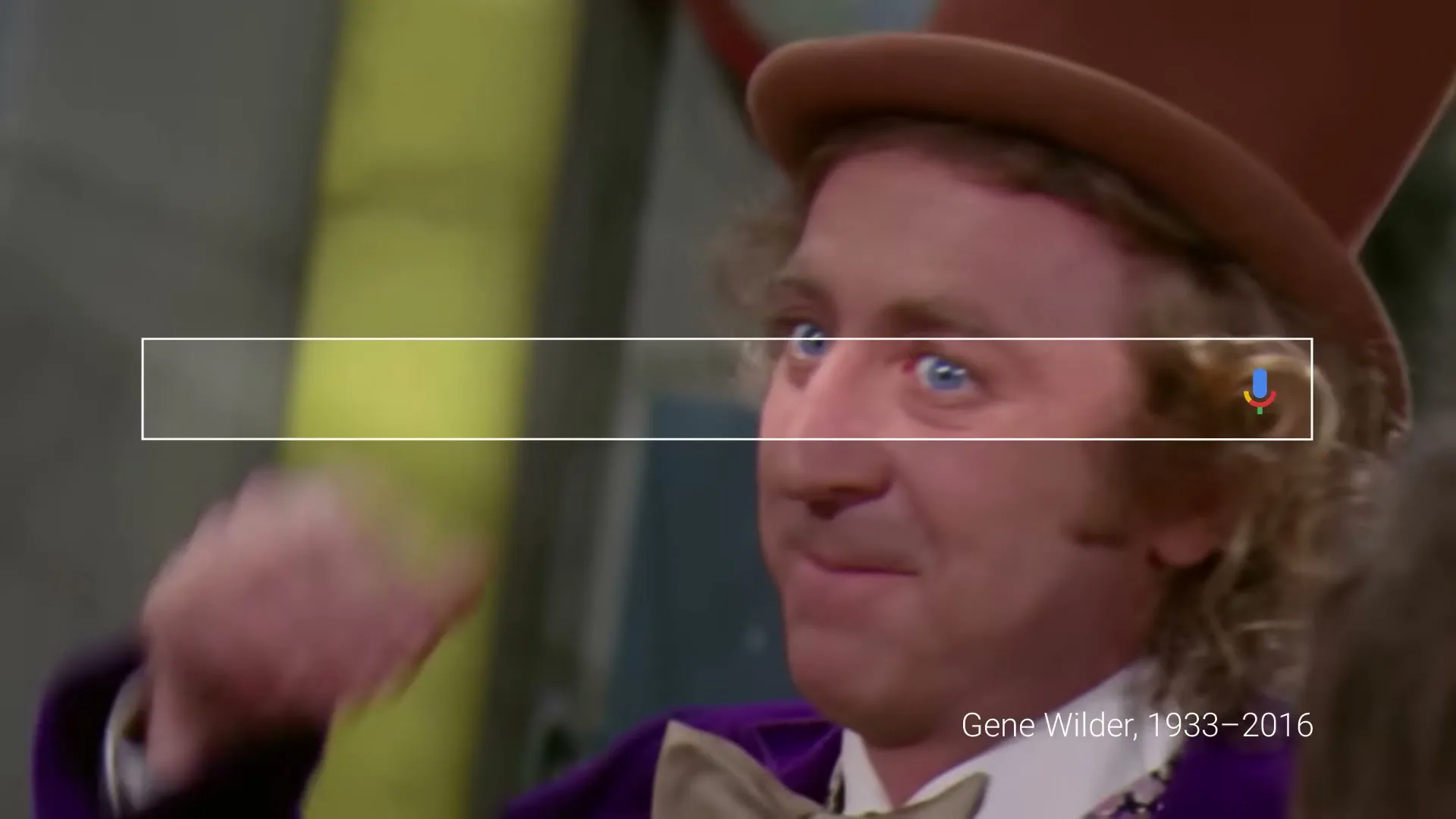 Gene Wilder as Willy Wonka, a male in a brown top hat and purple velvet coat, smiles and looks around in a factory setting.
