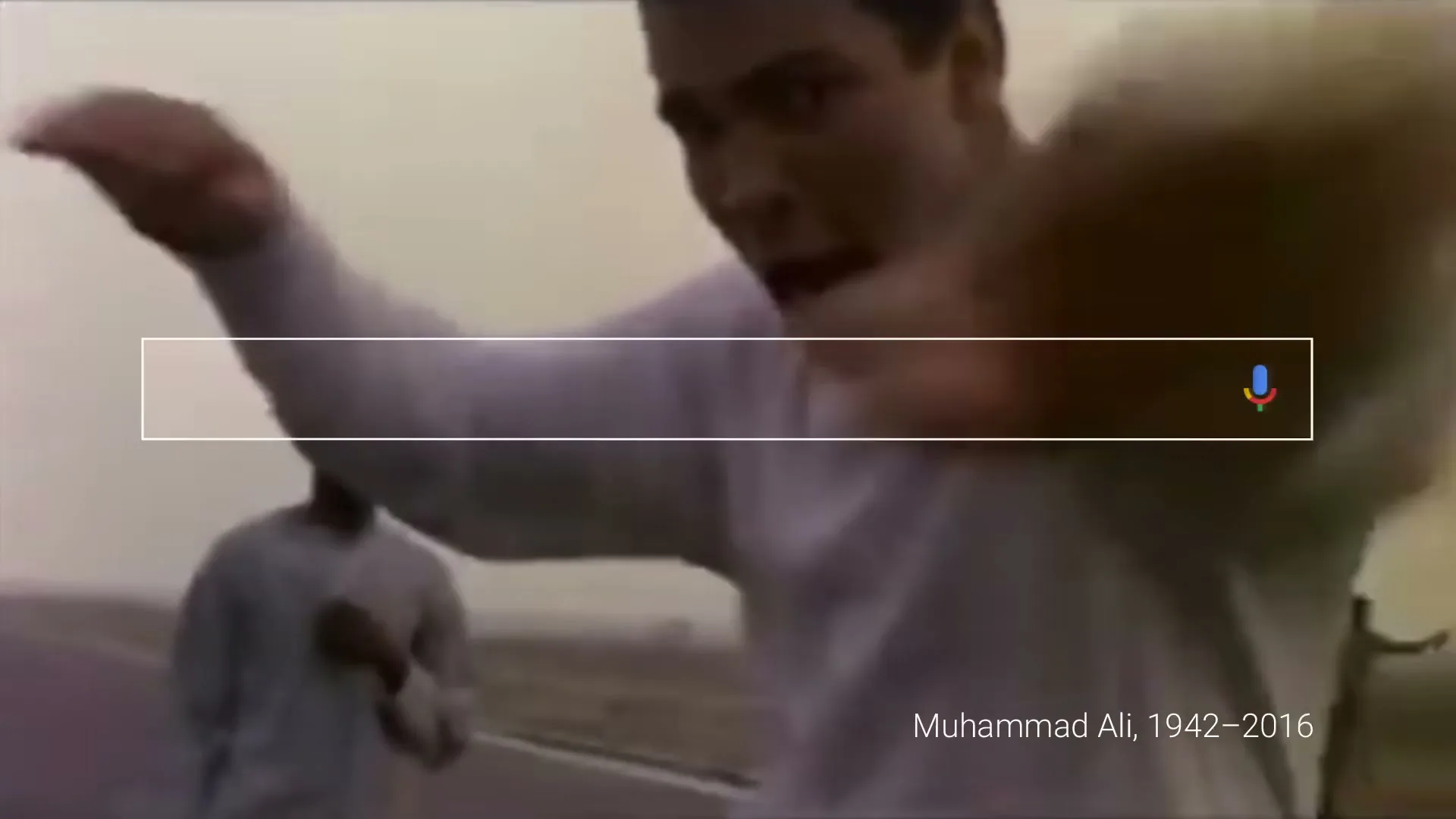 Muhammad Ali, a male boxer in his 30s, wearing a white long-sleeved shirt, gestures with his hands while running on a road with other people in the background.