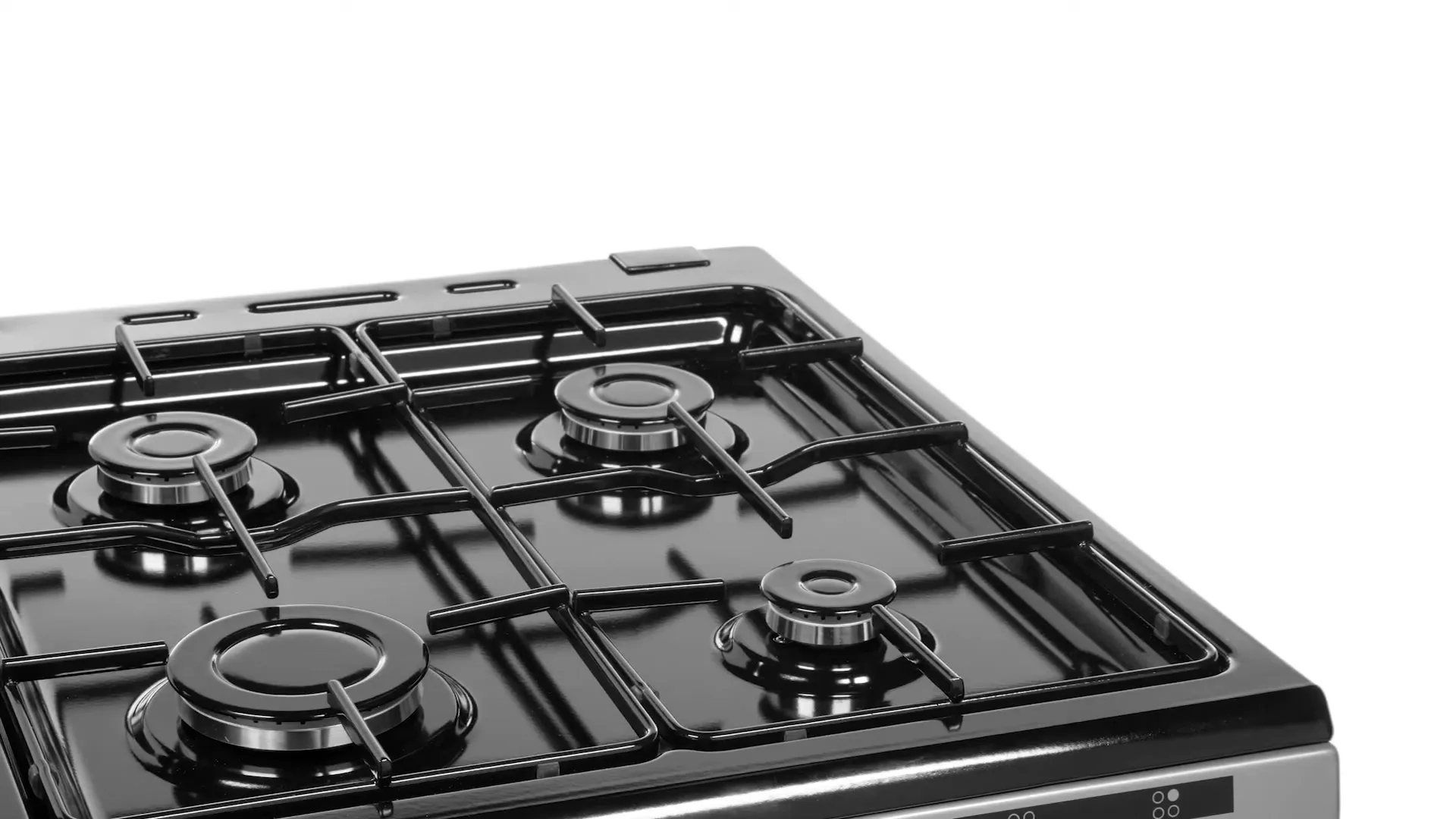 A clean, black gas stovetop with four burners is shown in a studio setting, ready for use.