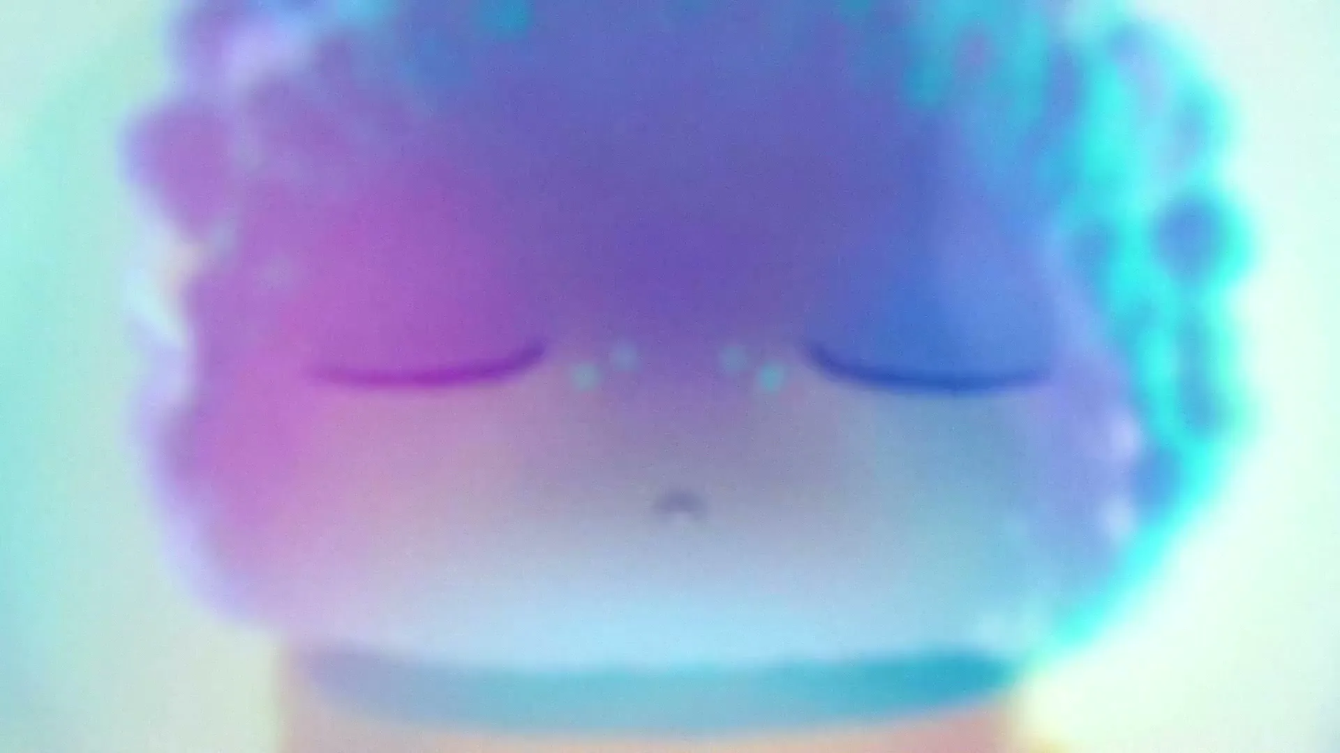A cute, fuzzy, purple and blue animated creature with large, glowing eyes slowly opens its eyes in a bright, ethereal space.