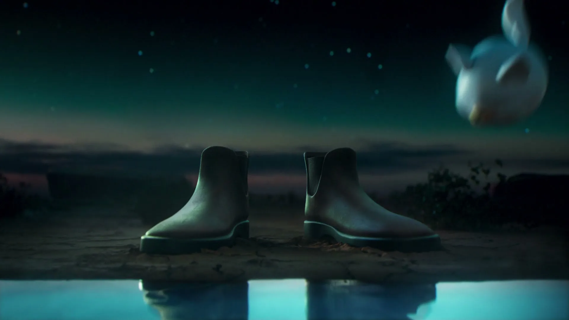 A pair of brown boots stands on the ground, then a small, white, spherical creature with ears and a yellow beak floats into view at night.