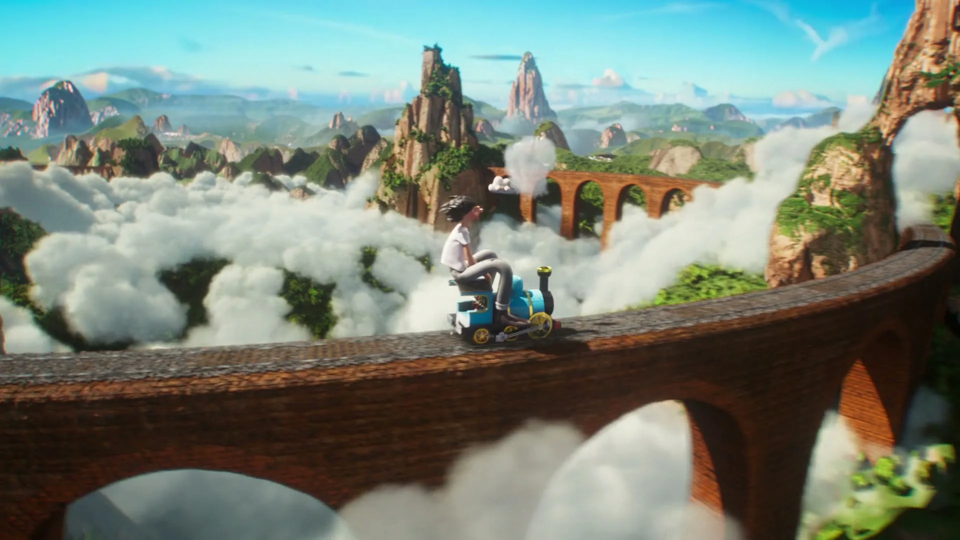 A young animated boy rides a small blue train on a brick bridge above clouds, with mountains in the background, then looks at a small white cloud with a face.