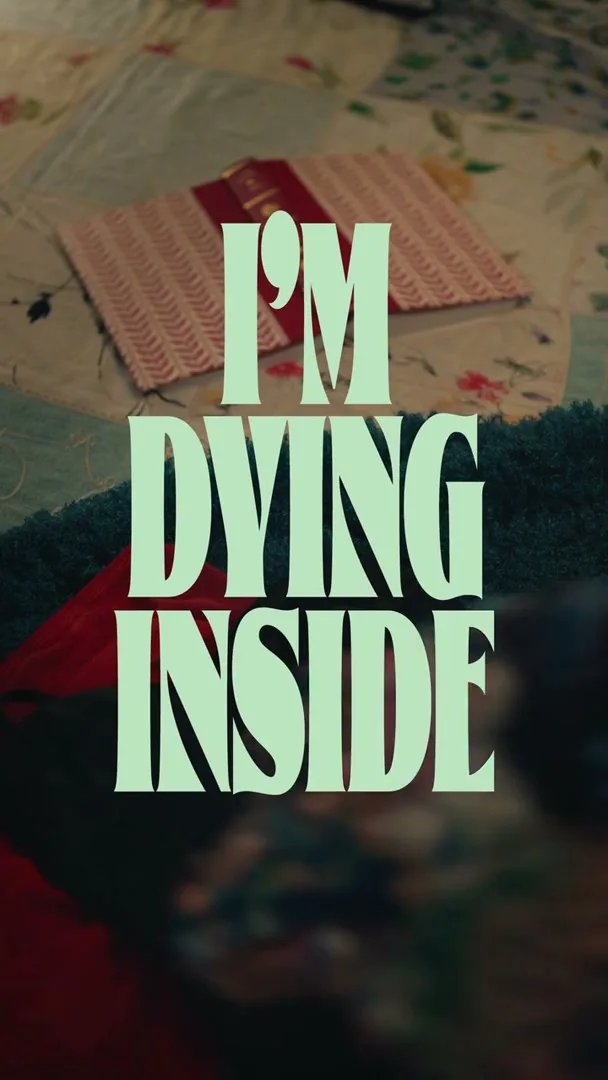 A title card with the words "I'M DYING INSIDE" in large, light green font, with "Episode 4" appearing below it, set against a soft-focus background of a patterned quilt.