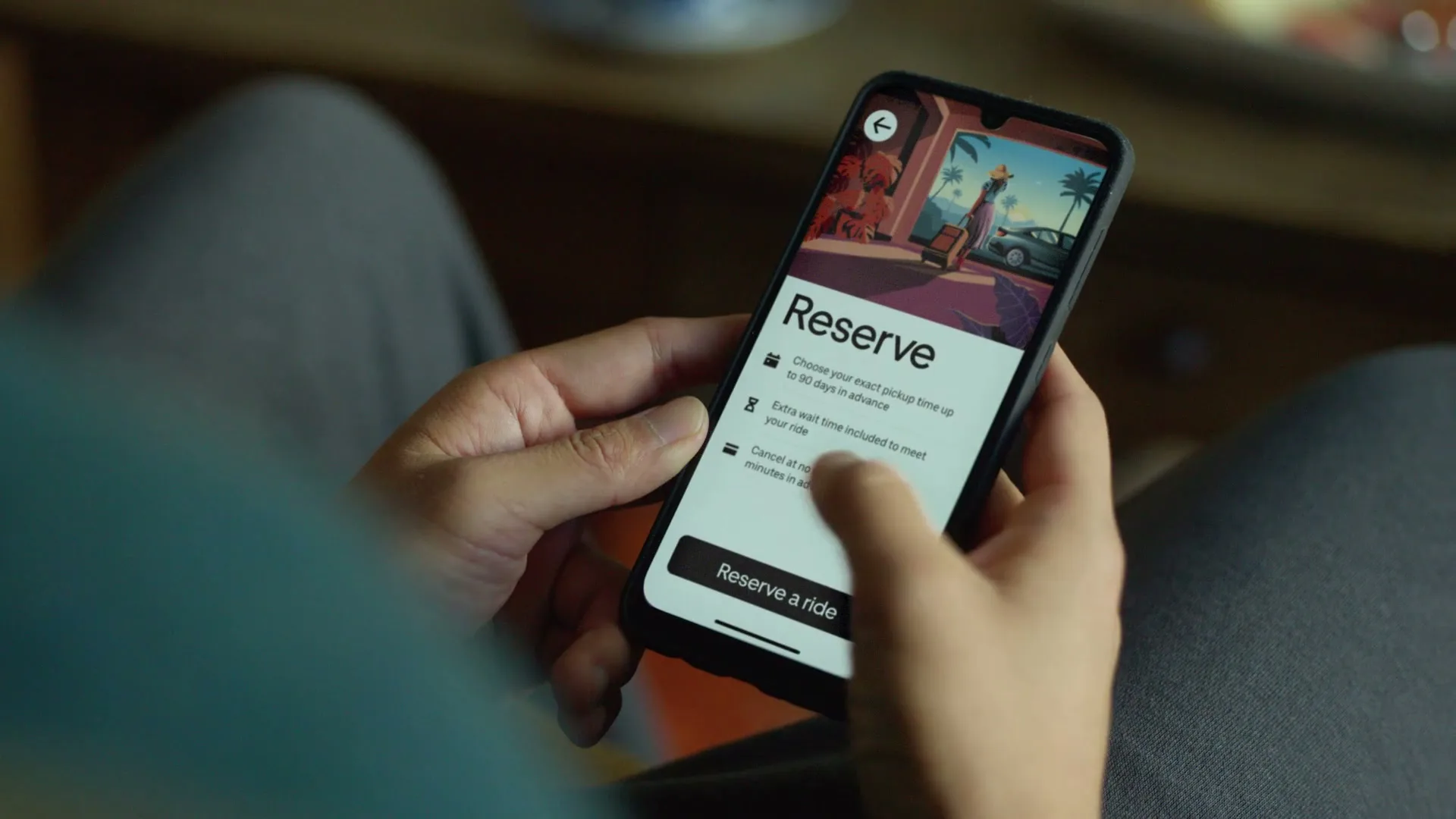 A person's hands hold a smartphone displaying the Uber app's "Reserve" screen, then taps "Reserve a ride" and the screen changes to "Where would you like to be picked up?".