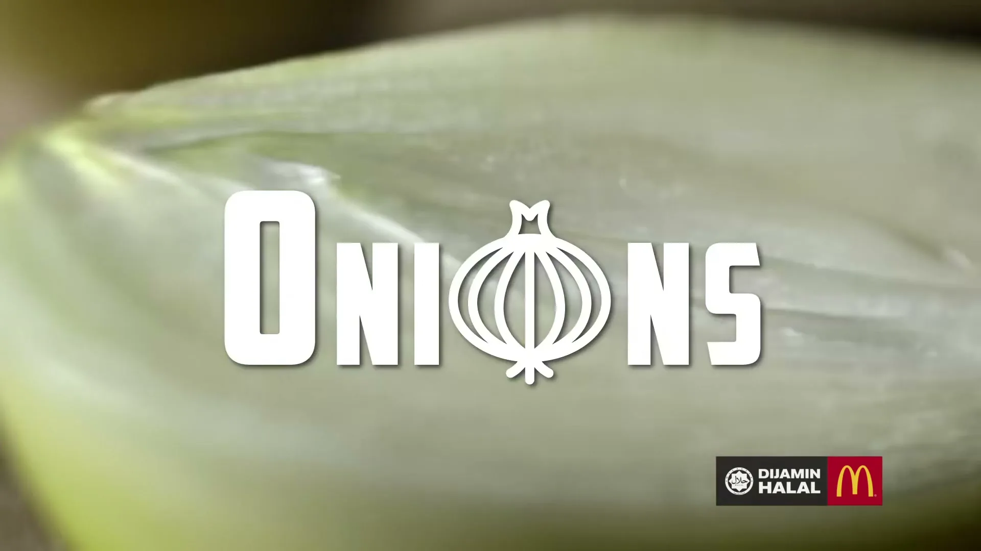 A macro shot of a sliced onion with the word "Onions" appearing on screen, highlighting an ingredient.