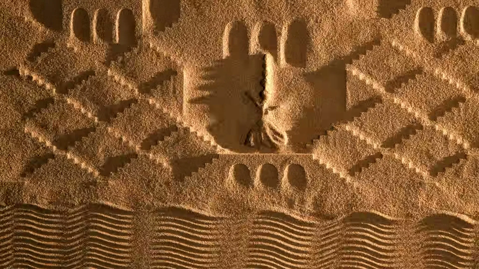 A hand draws a stylized image of a person on a sandy surface, surrounded by geometric patterns and arches, resembling a desert landscape.