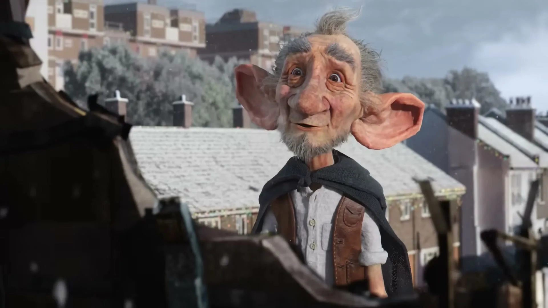 A stop-motion animated old man with large ears and a beard looks up from behind a fence in a snowy suburban neighborhood.