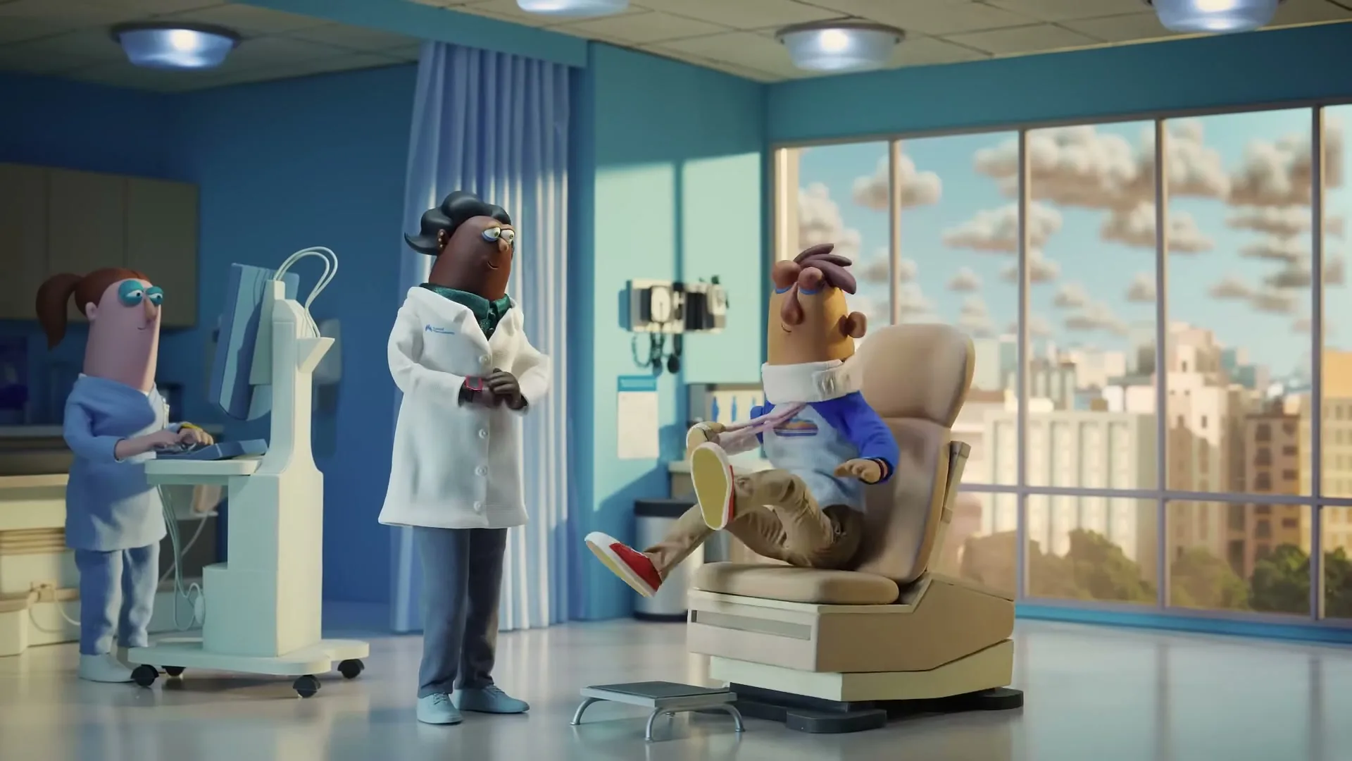 A claymation doctor in a white coat talks to a patient in a neck brace sitting in a floating chair, while a nurse works at a computer in a hospital room.
