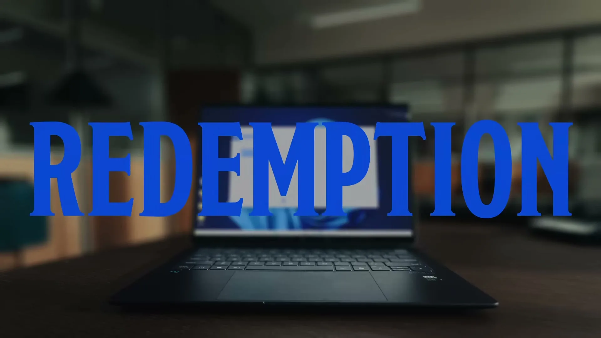 The word "REDEMPTION" in blue text is superimposed over a laptop on a desk in an office setting.
