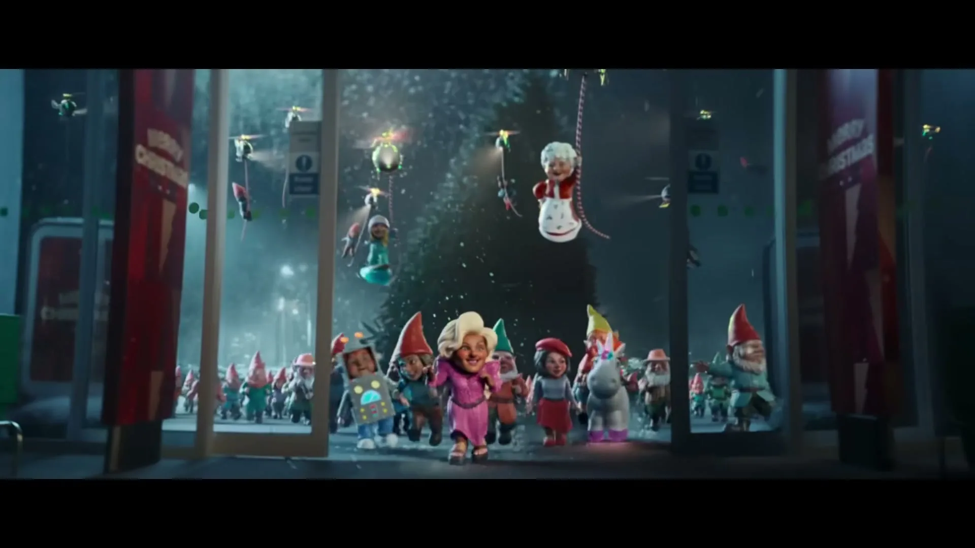 A large group of animated gnomes, including one in a pink outfit and another dressed as a robot, run out of an Asda supermarket entrance at night.