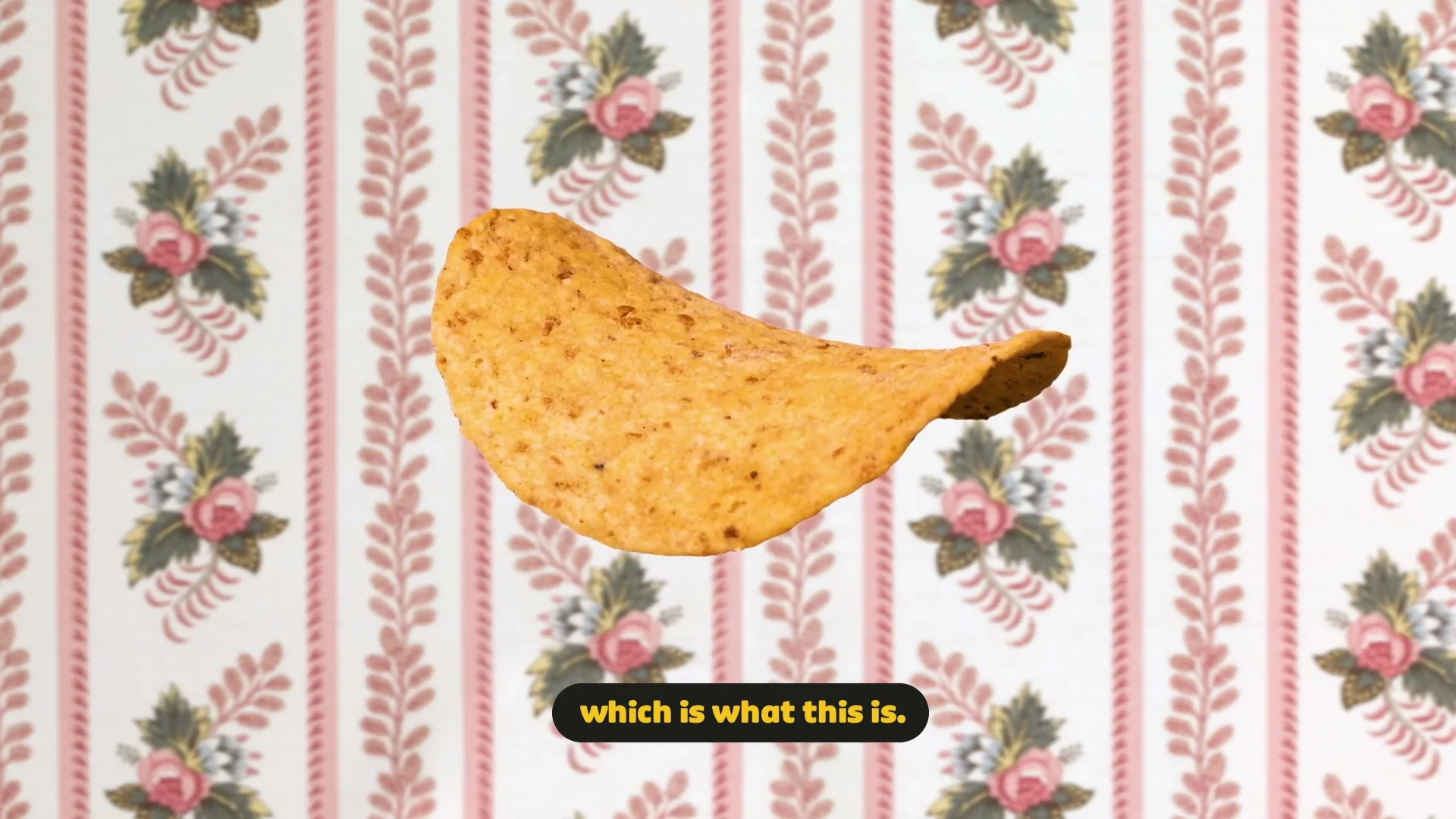 A single Pringles multigrain chip floats in front of a pink floral wallpaper background, with text appearing and disappearing at the bottom of the screen.