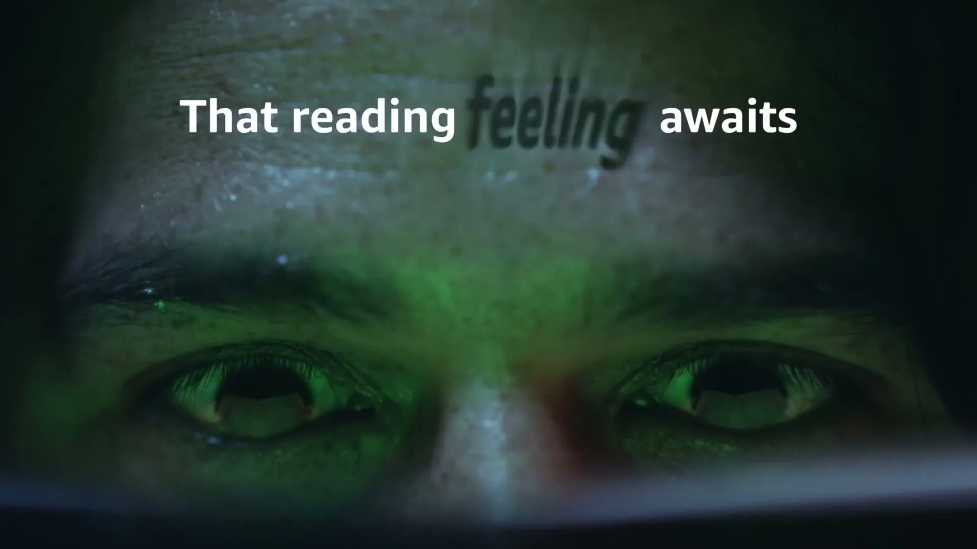 A person's eyes are illuminated by a green glow, with the text "That reading feeling awaits" superimposed on their forehead.
