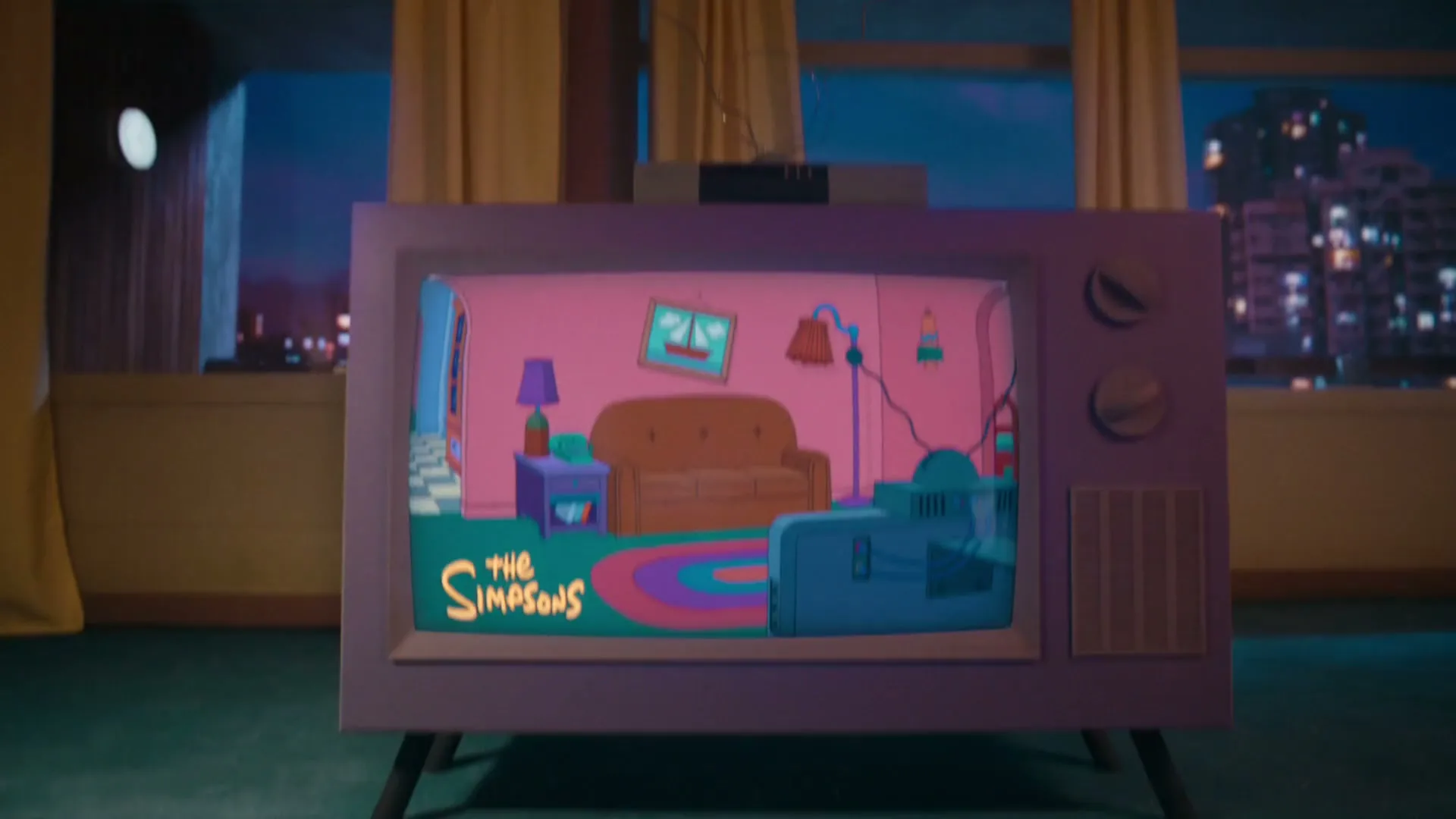 A vintage television set displays an animated scene of The Simpsons family in their living room, set against a backdrop of a city at night.