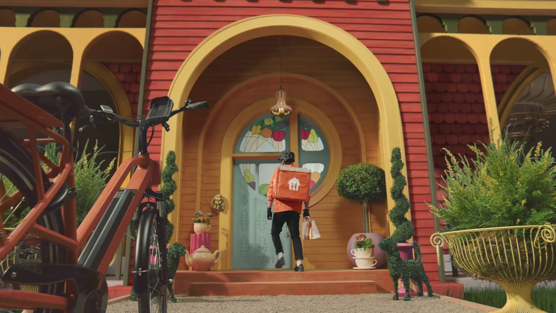 A delivery person in an orange jacket walks up the steps to a whimsical, colorful house with a bicycle in the foreground.