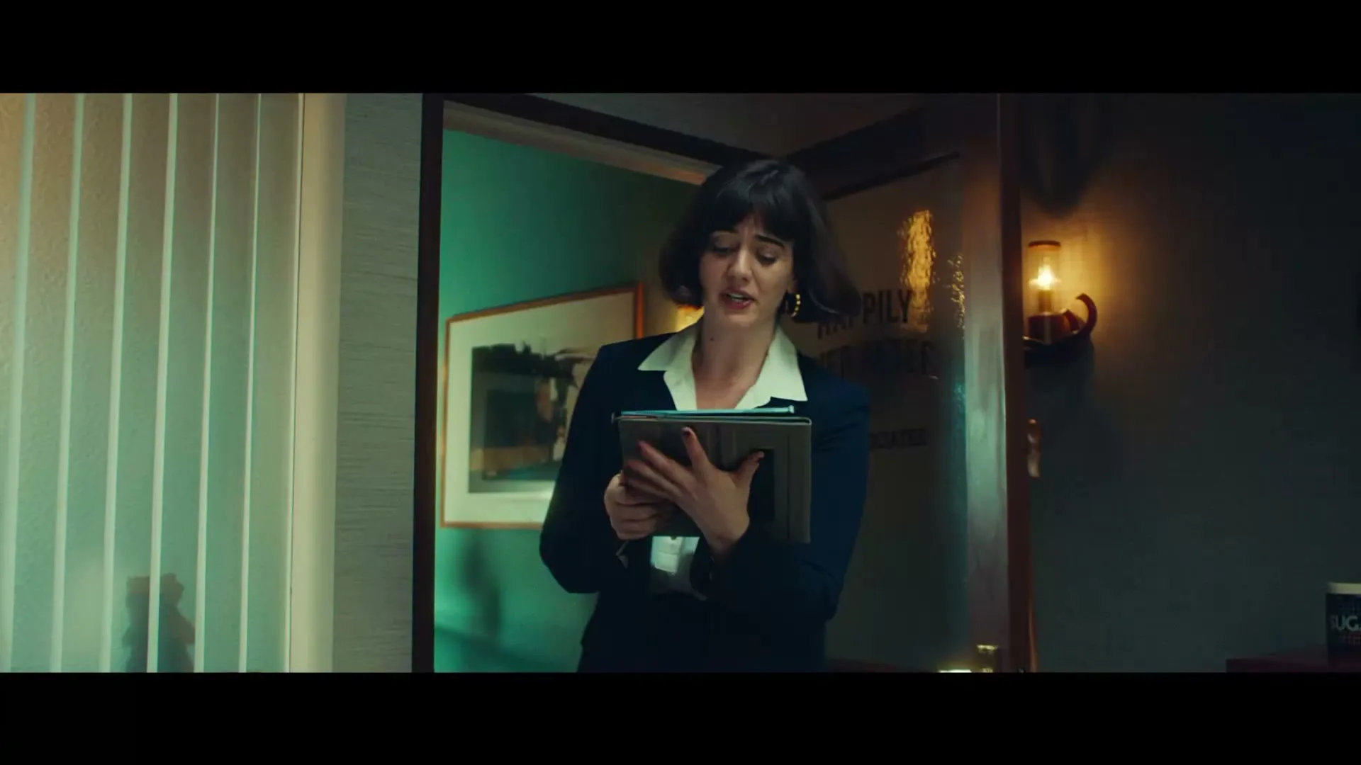 A young woman in a suit and white shirt enters an office, holding a tablet and speaking, with a sign on the door reading "Happily Ever After Law Associates."