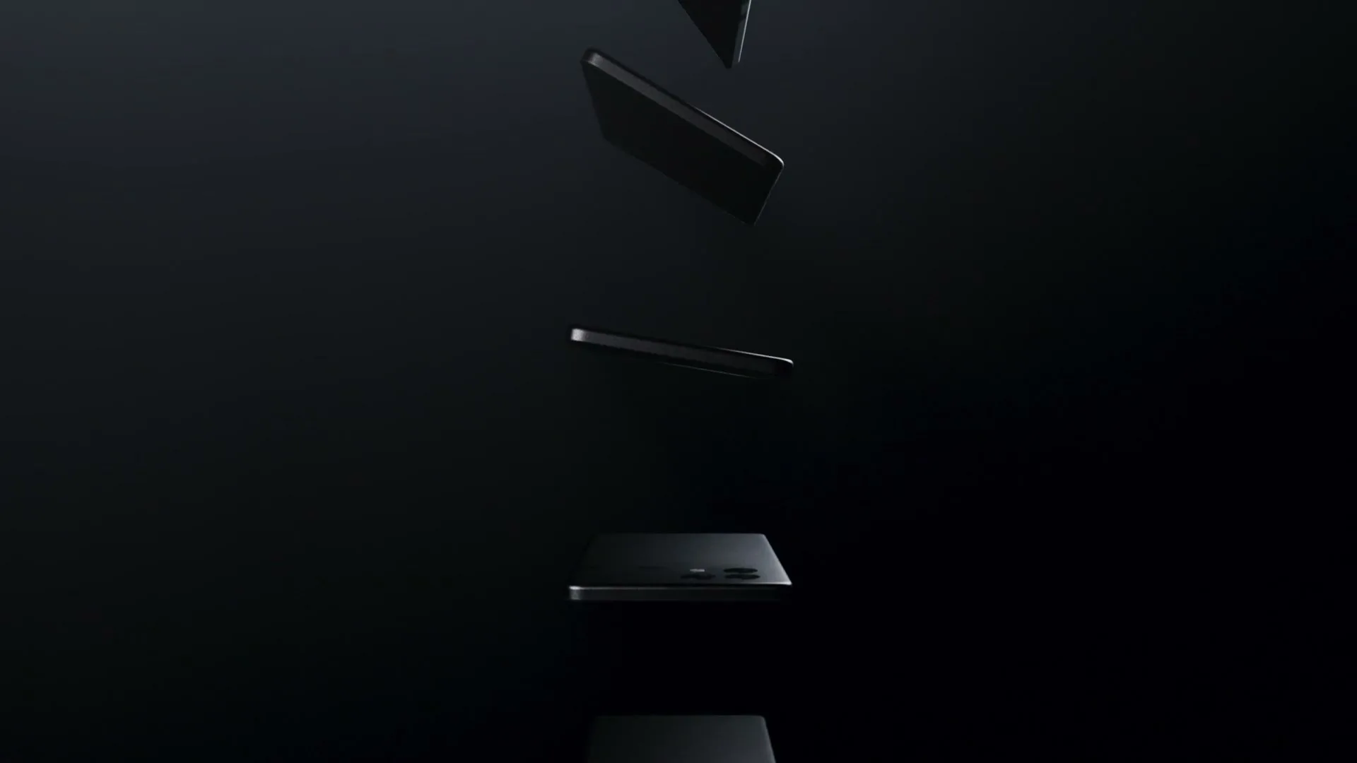 Multiple black smartphones fall through a dark void, rotating as they descend, with a subtle light catching their edges.