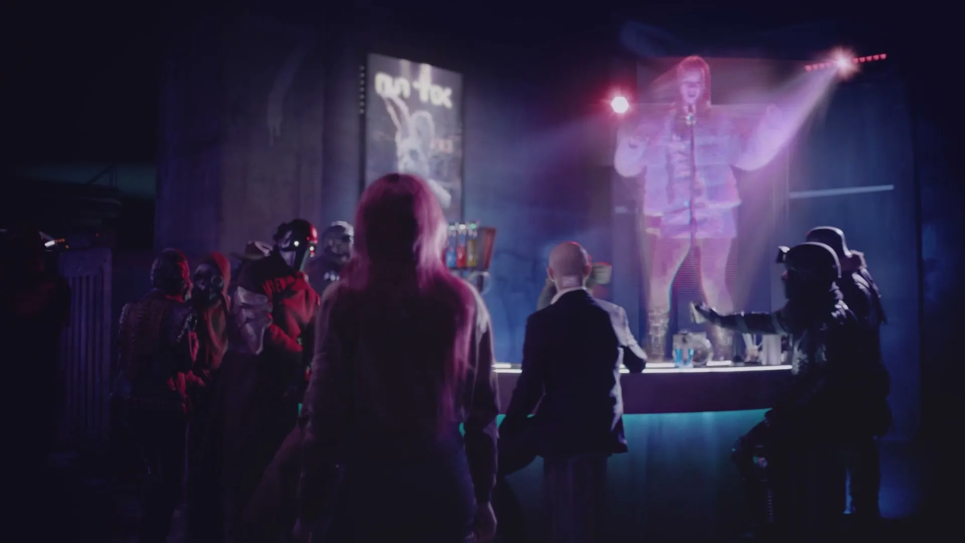 A woman with pink hair stands in a dark, futuristic club, looking at a holographic DJ and other patrons.