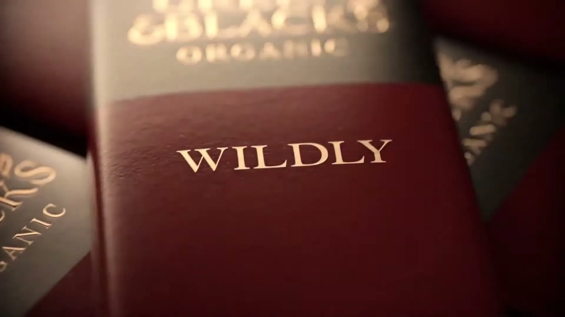 A close-up shot of a Green & Black's chocolate bar wrapper with the word "WILDLY" prominently displayed.