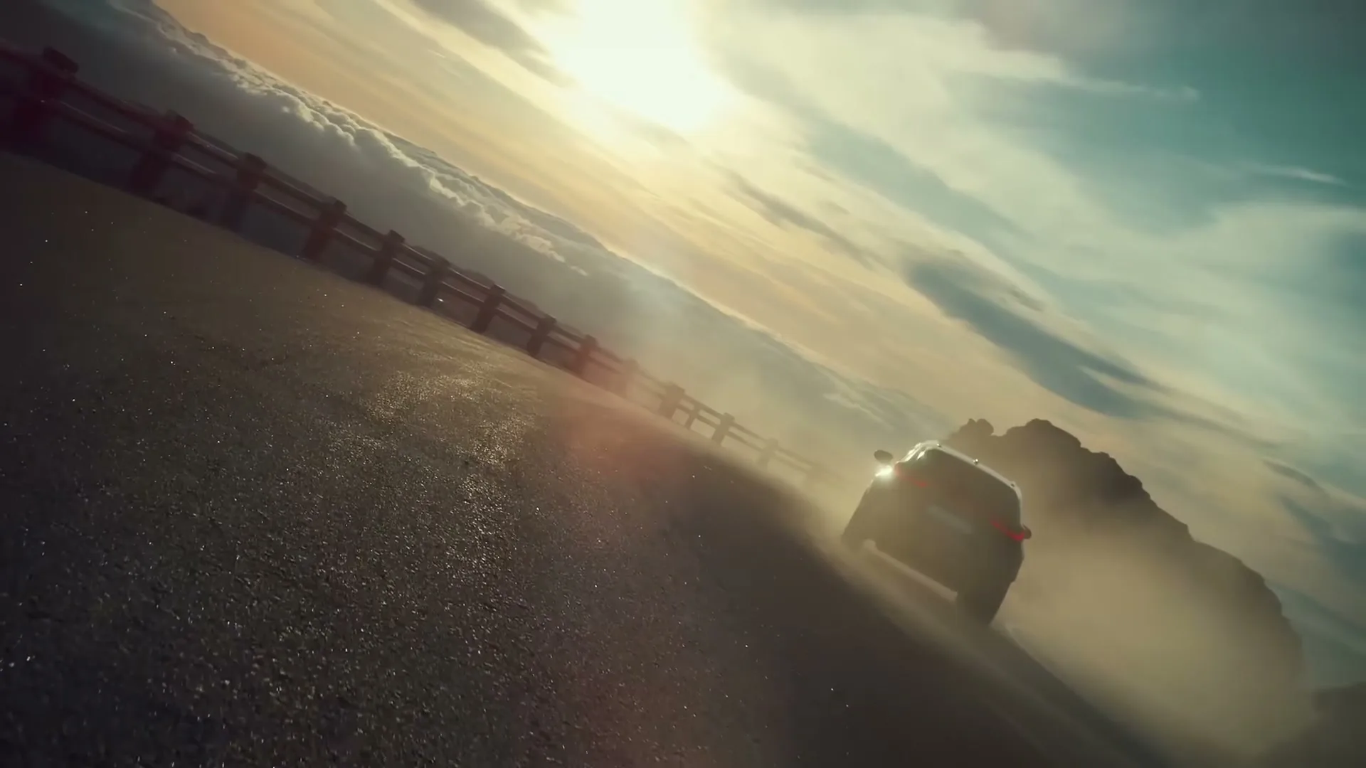 A dark Lexus SUV drives away from the camera on a mountain road at sunset, kicking up dust.