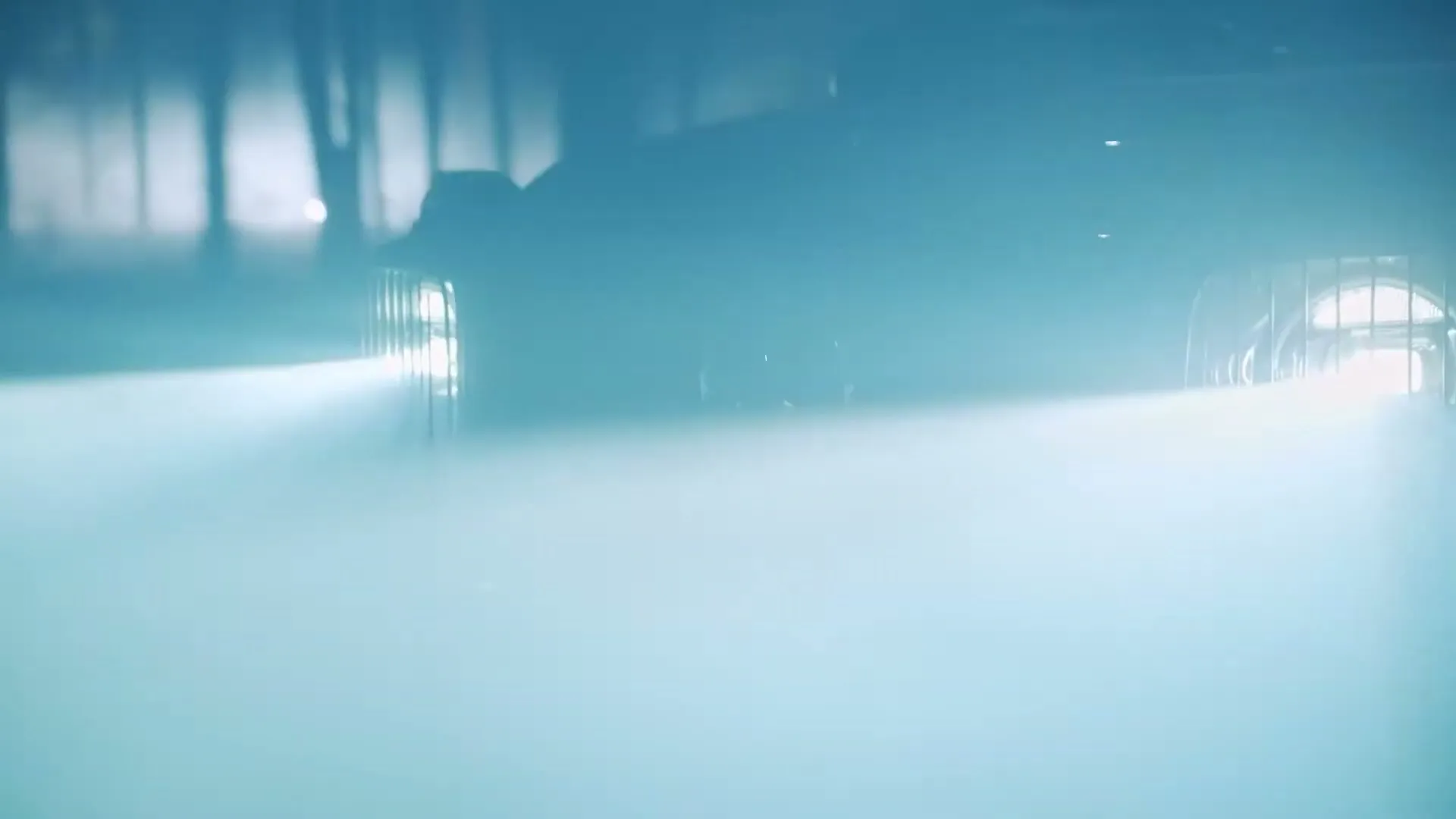 A vintage Mercedes-Benz G-Wagen drives through a foggy, dark tunnel, its headlights cutting through the mist.