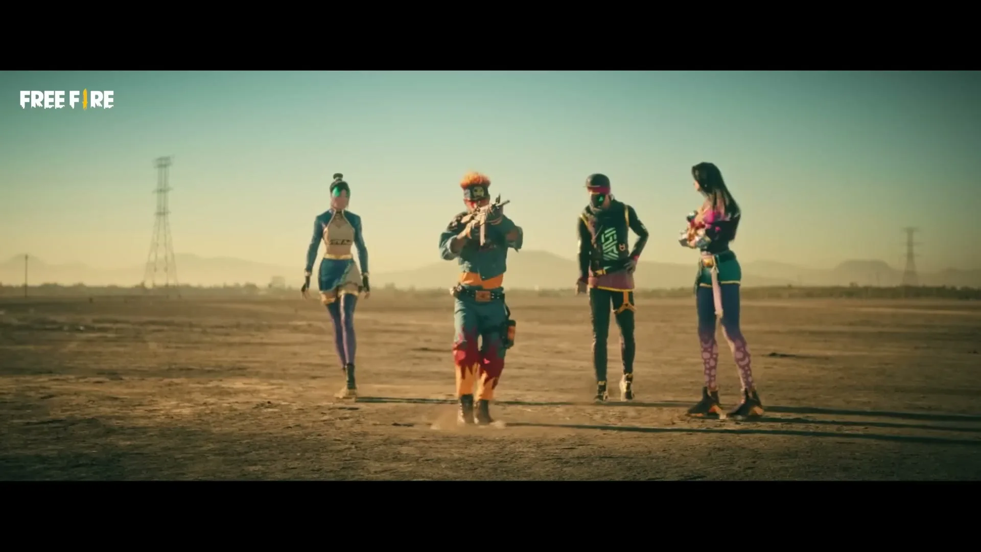 Four diverse young adults in colorful, futuristic outfits dance in a barren desert landscape under a clear sky, with one holding a rifle.
