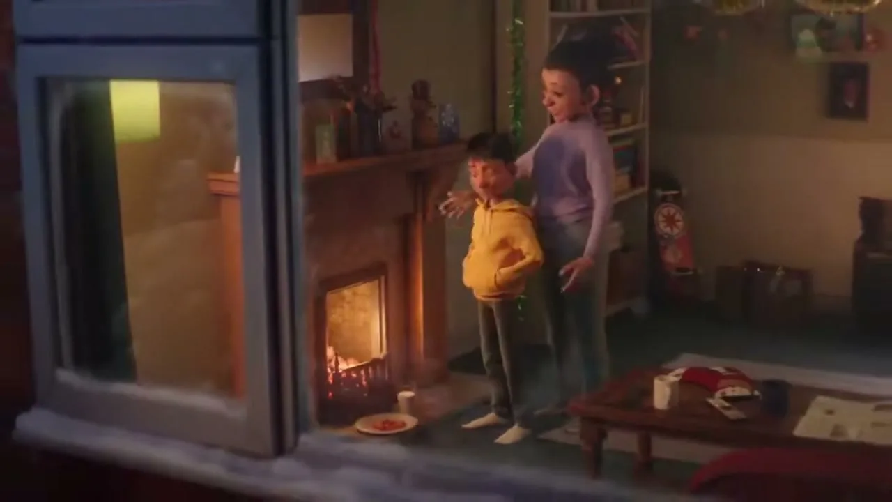 A young boy in a yellow hoodie places a plate of cookies by a fireplace, while a woman in a purple sweater watches him in a cozy living room.
