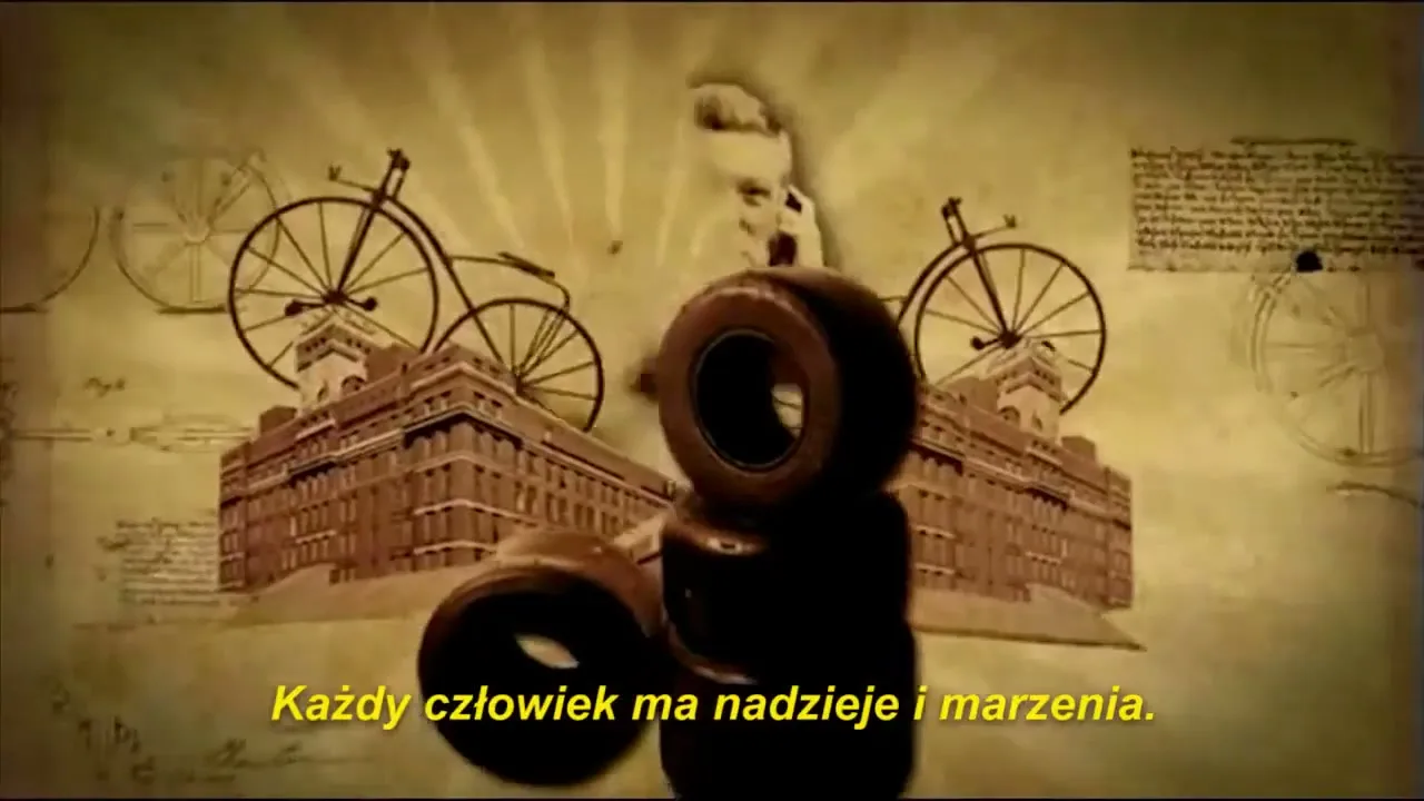 A stack of dark tires is centered on a sepia-toned background with historical drawings of bicycles, buildings, and a bearded man, with Polish text at the bottom.