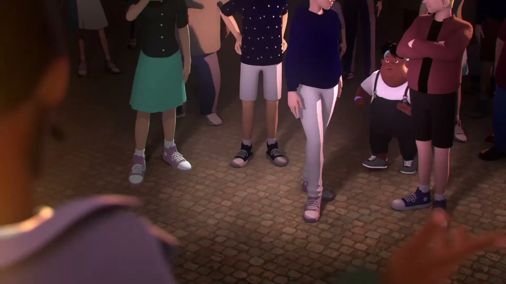 A diverse group of animated people stand on a cobblestone street at night, looking at someone off-screen.