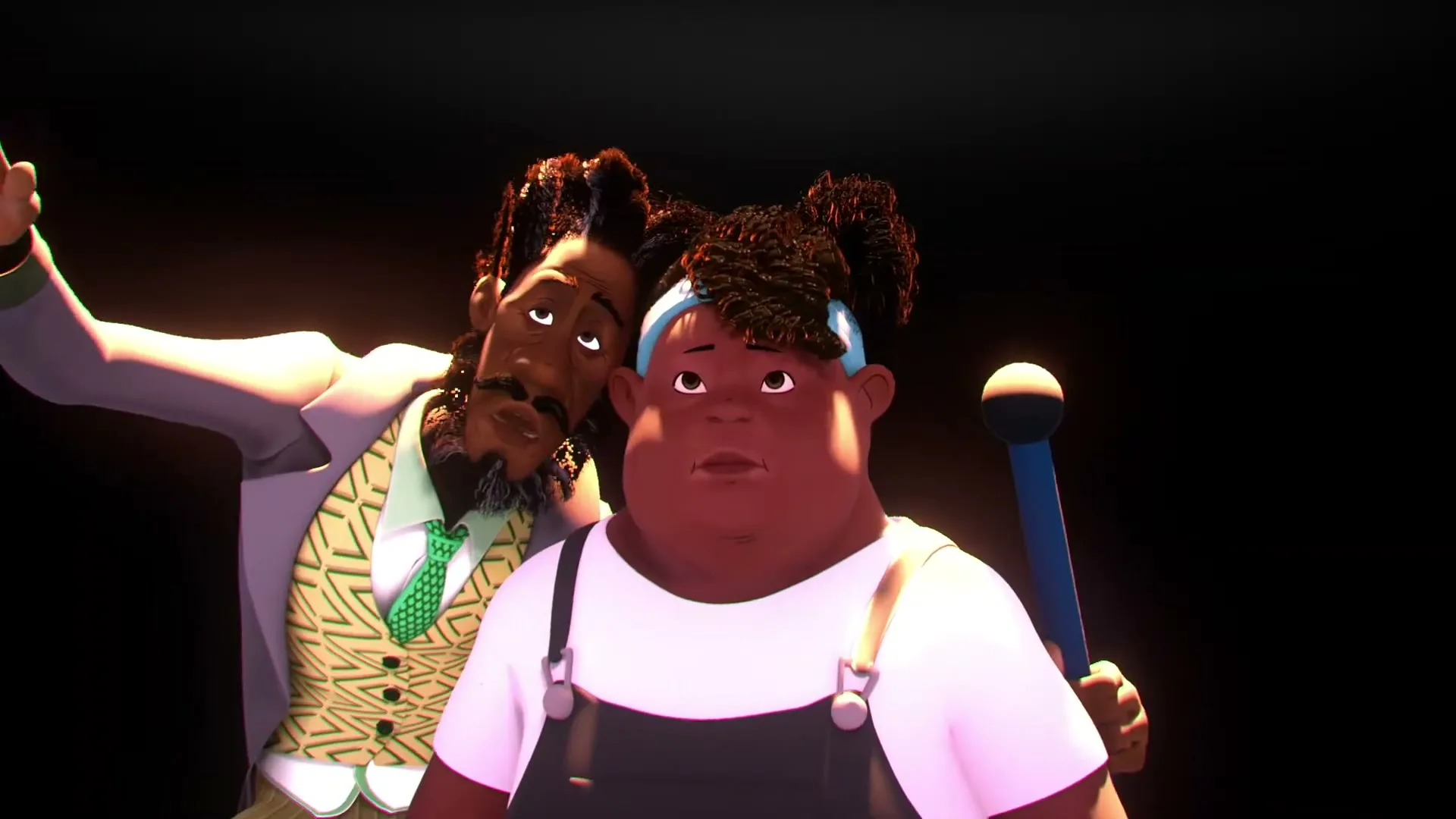 A man with dreadlocks and a beard whispers into the ear of a young girl with pigtails, who holds a blue microphone, against a black background.