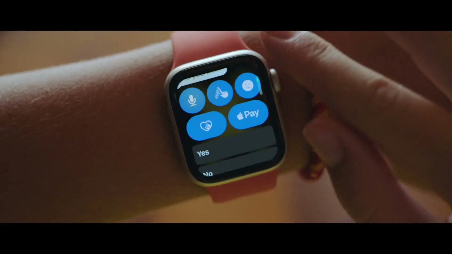 A person's arm with an Apple Watch on their wrist, displaying a text message from "Sydney" asking "Did you win?" The person taps the screen to reply.