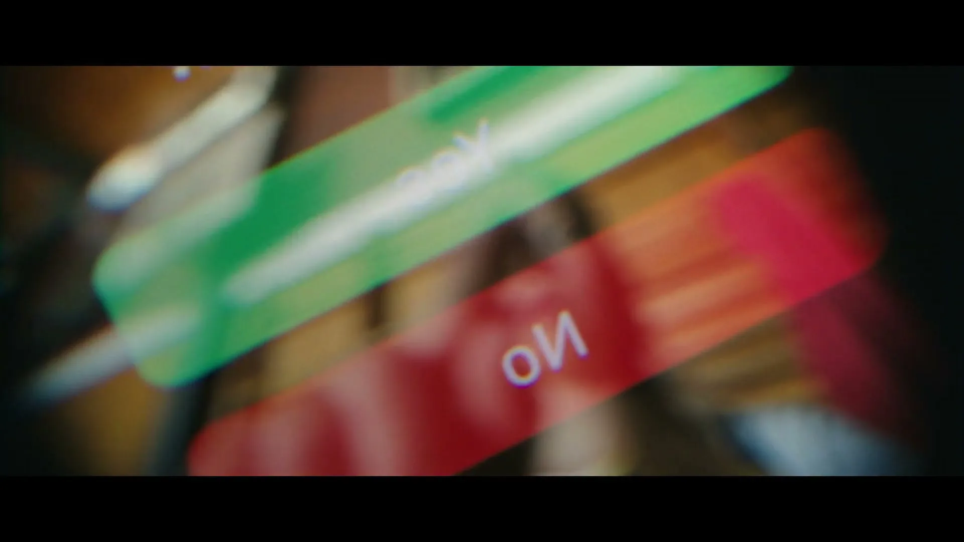 A young woman with blonde hair looks up at the camera, with blurred green and red shapes in the foreground, in a gym.