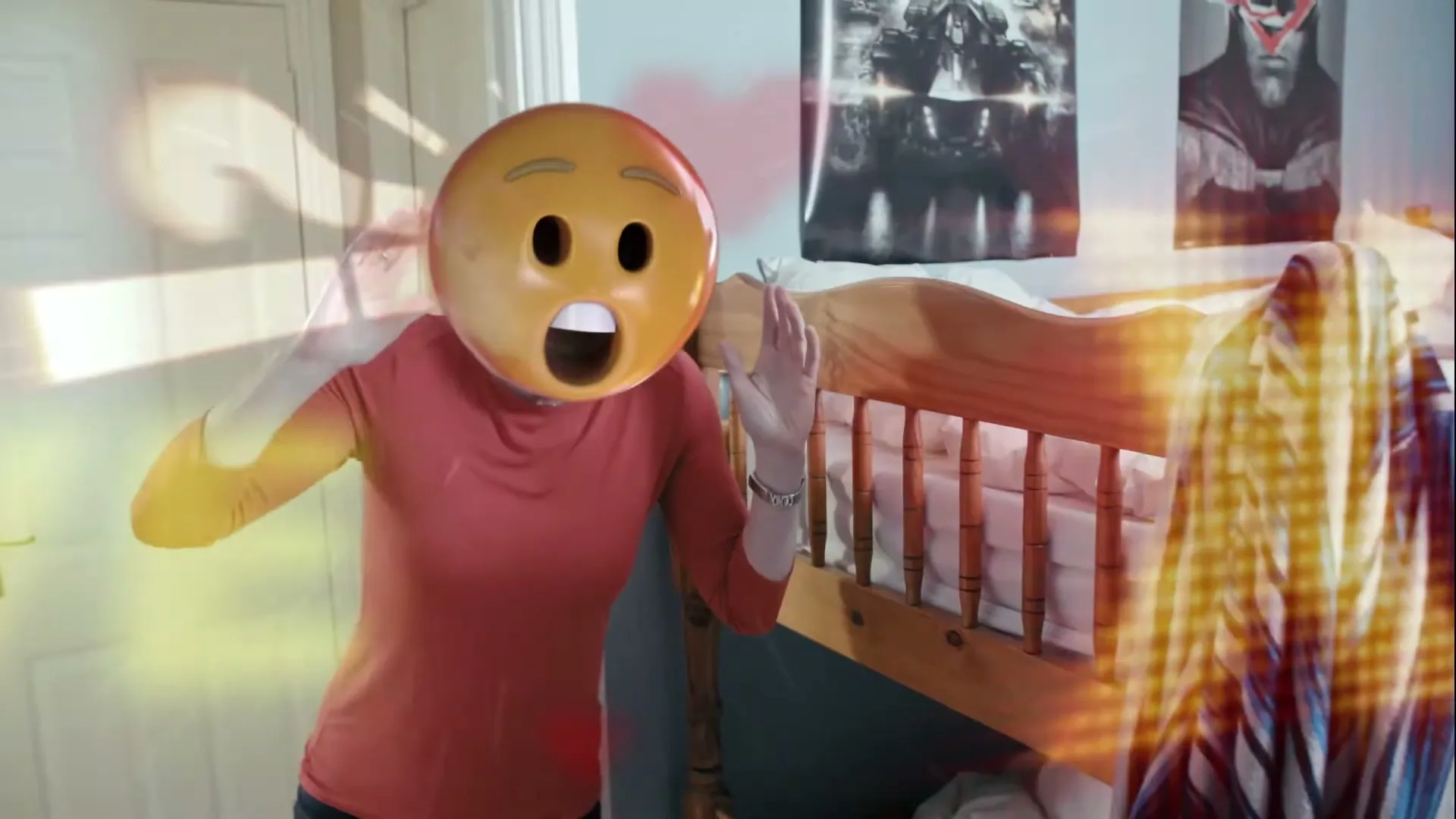 A person wearing an emoji mask with a shocked expression stands next to a wooden bunk bed in a bedroom, surrounded by glowing digital effects.