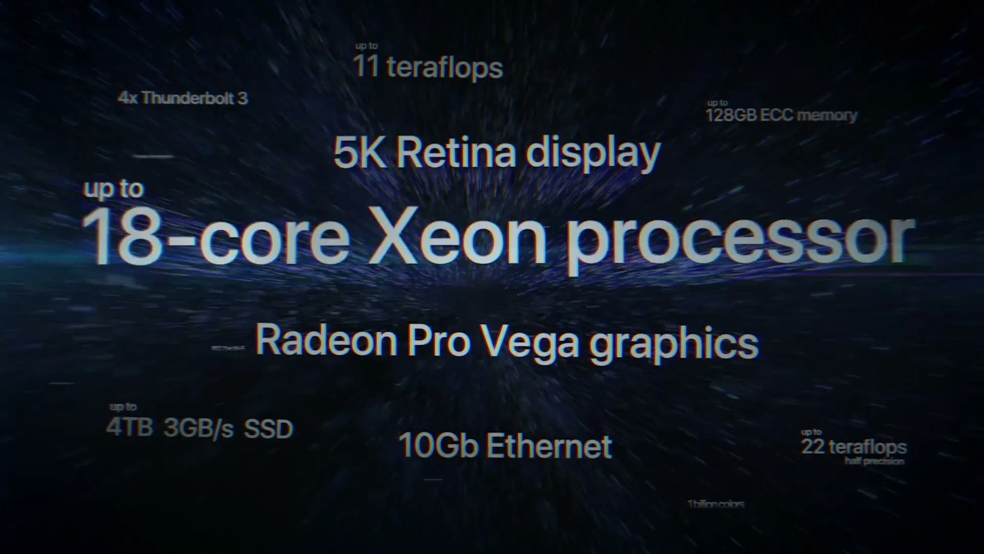 A dark screen with white text displaying various computer specifications, including "18-core Xeon processor" and "5K Retina display," with a blue light streak across the center.