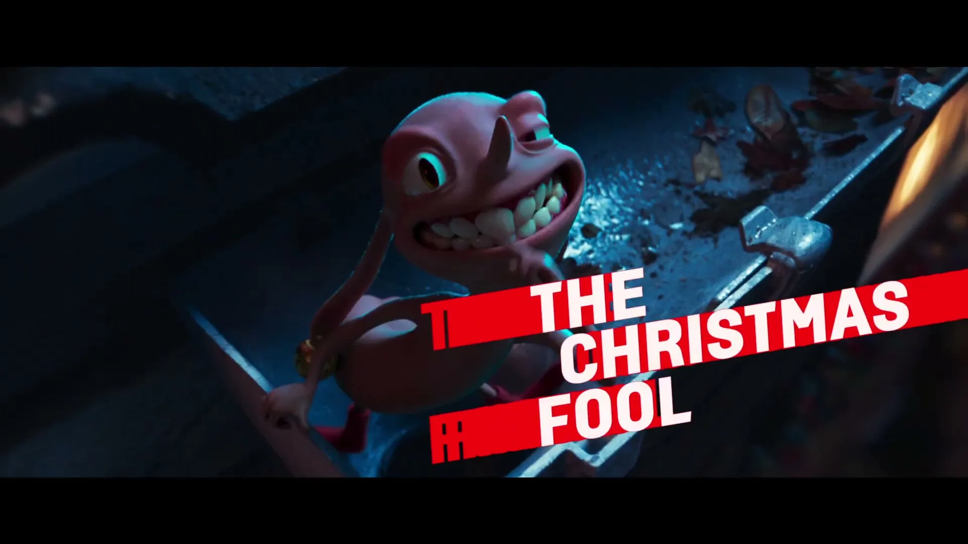 A pink, cartoonish creature with large teeth and a mischievous expression emerges from a gutter, then disappears, with text "THE CHRISTMAS FOOL" appearing on screen.